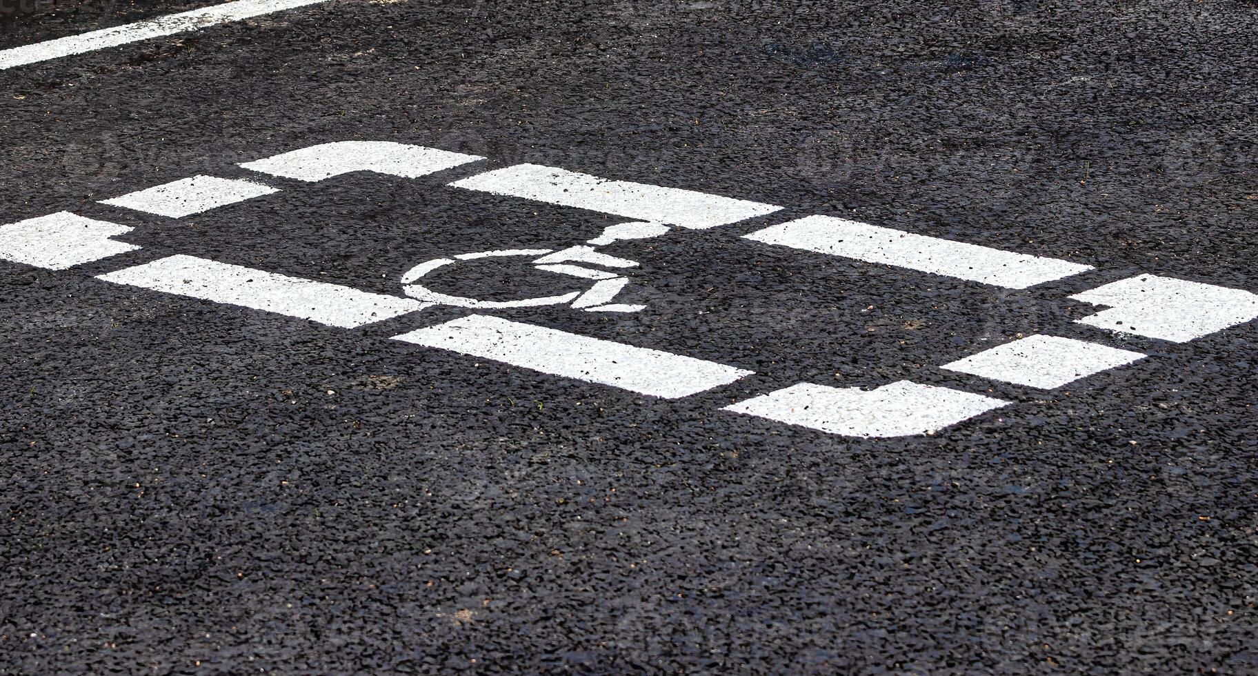 Parking lot with disabled parking sign on asphalt. Parking for a photo