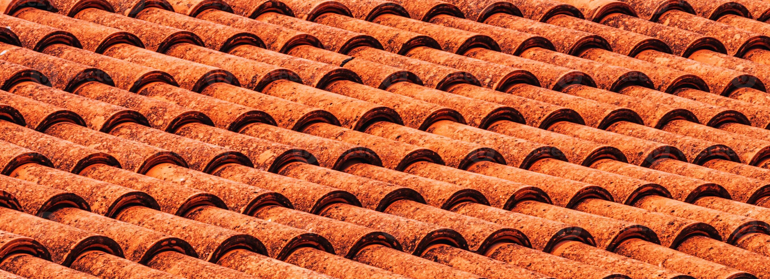 Texture of red clay roof tiles. Abstract backdrop for design. photo