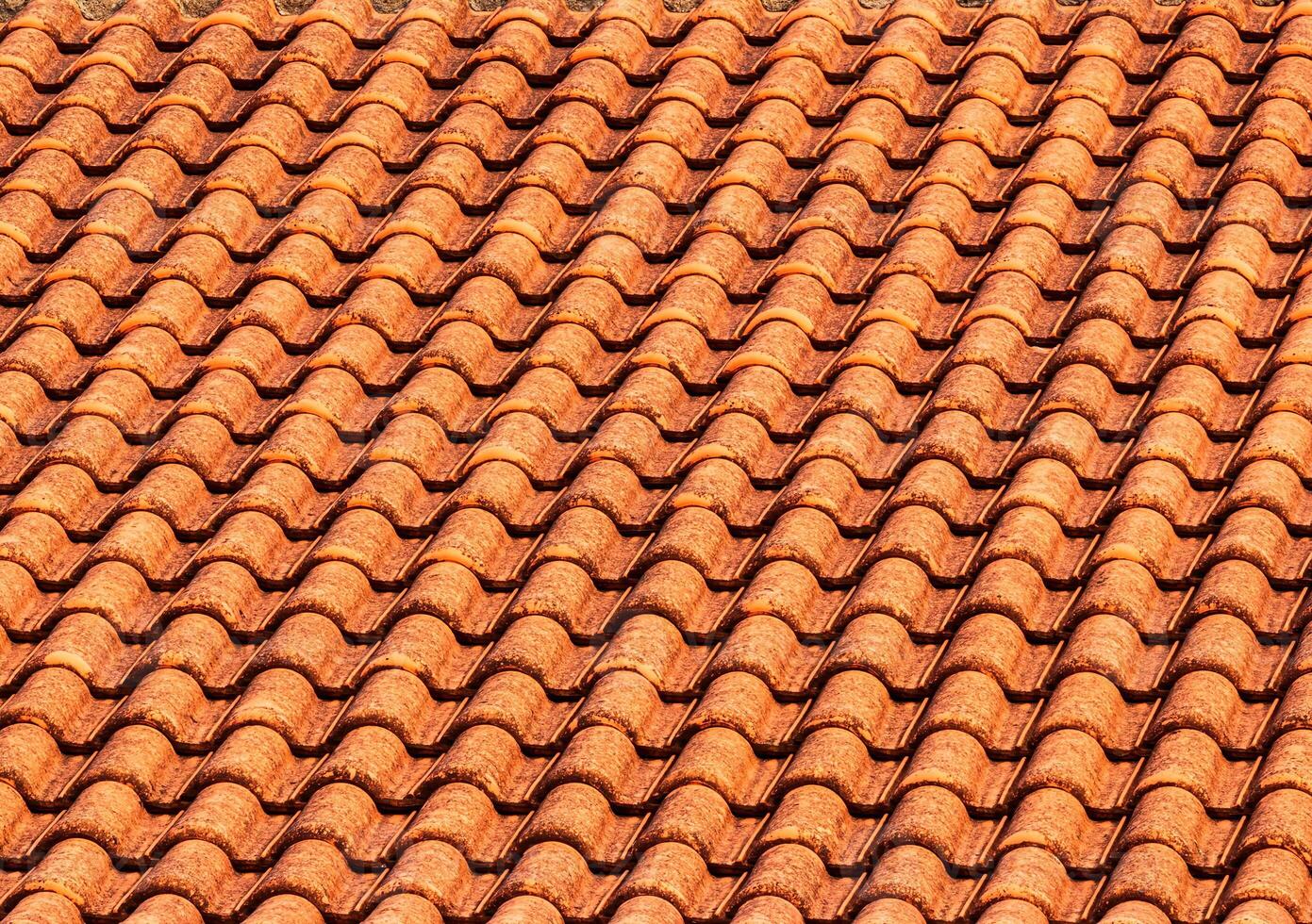 Texture of red clay roof tiles. Abstract backdrop for design. photo