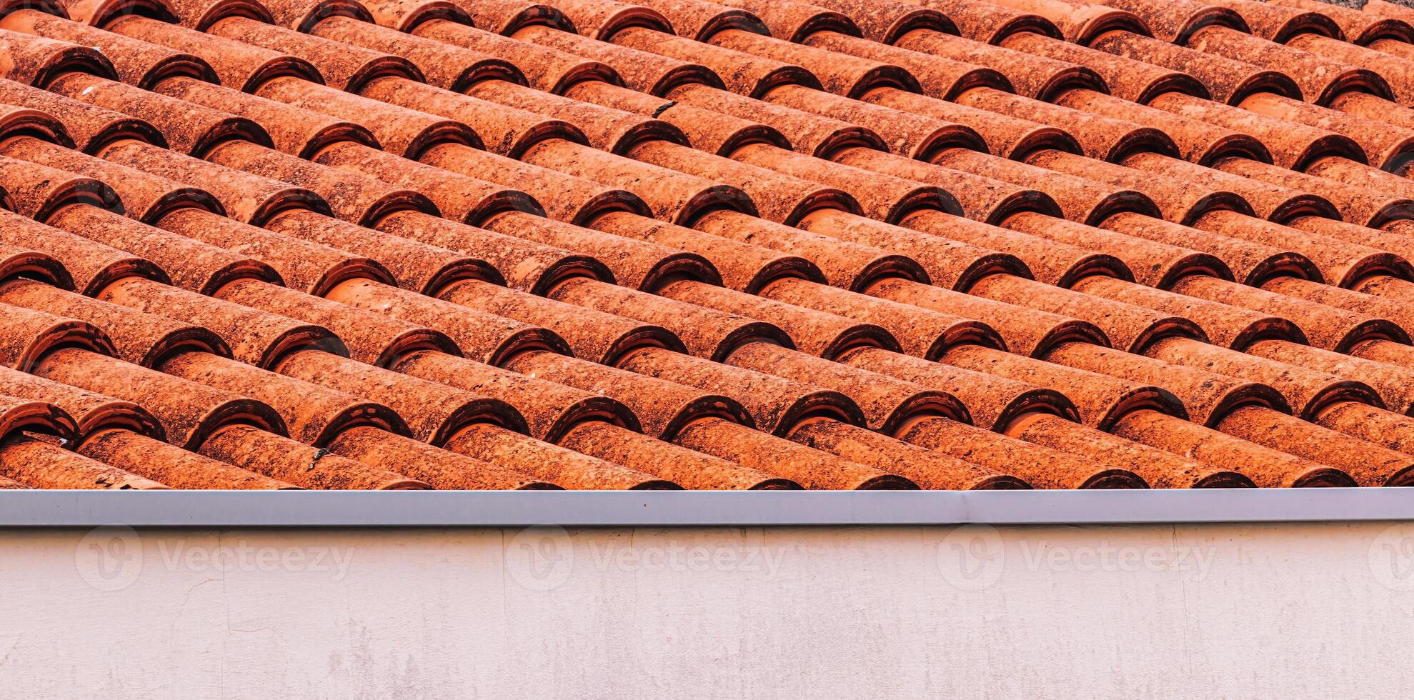 Texture of red clay roof tiles. Abstract backdrop for design. photo