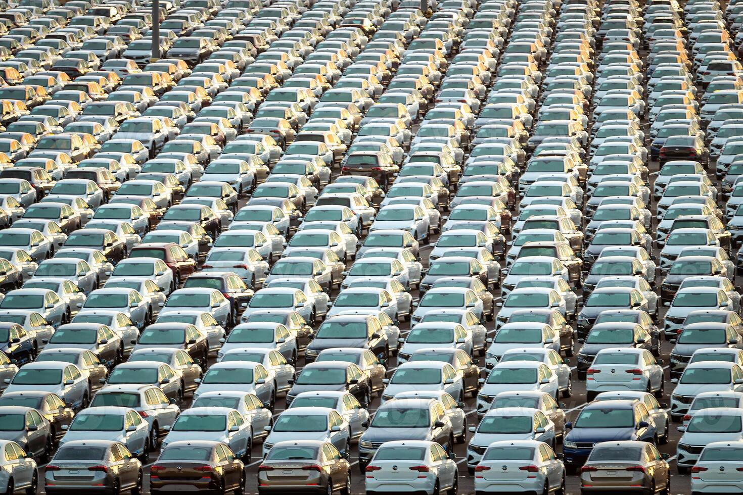 Volkswagen Group Rus, Russia, Kaluga - MAY 25, 2020 Rows of a new cars parked in a distribution center on a sunny morning in the autumn. photo