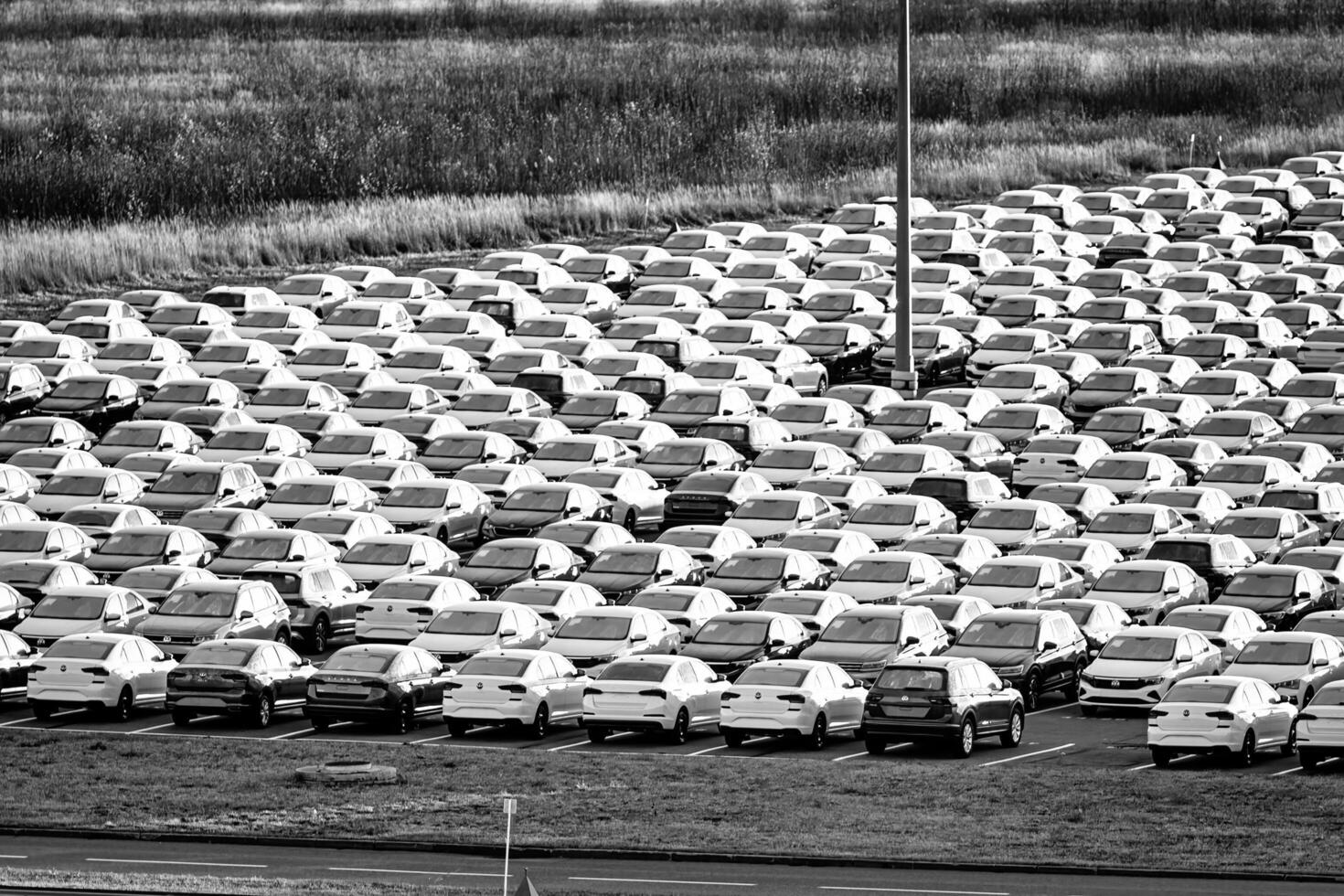 Volkswagen Group Rus, Russia, Kaluga - NOVEMBER 17, 2020 Rows of a new cars parked in a distribution center. Parking in the open air. photo
