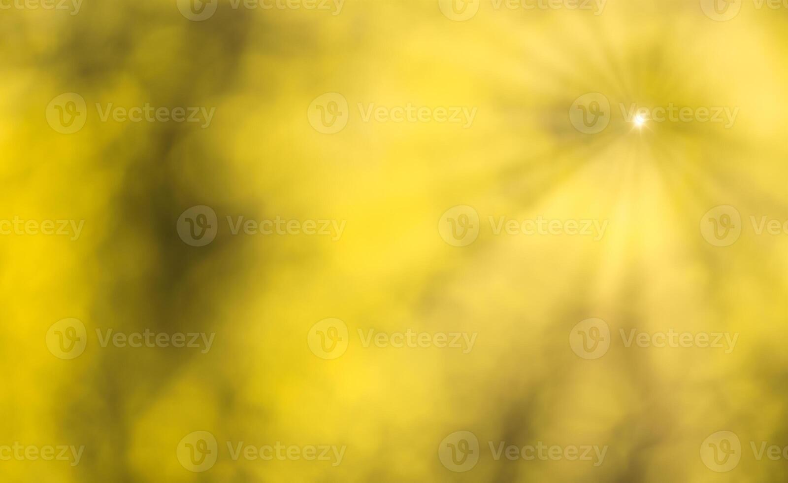 Blurred bokeh background image of bright yellow foliage and sunbeams in autumn. photo