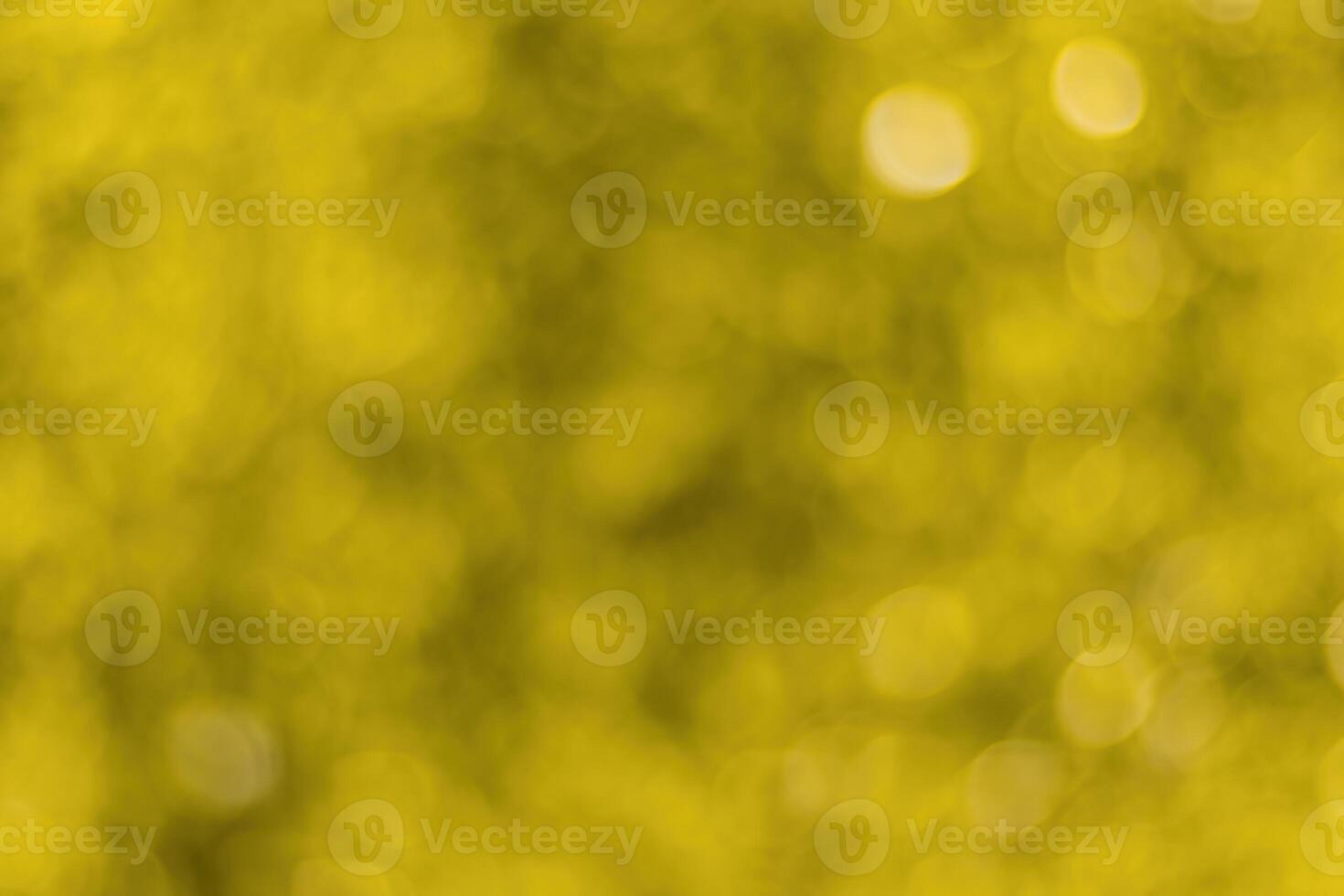 Blurred bokeh background image of bright yellow foliage in golden autumn. photo