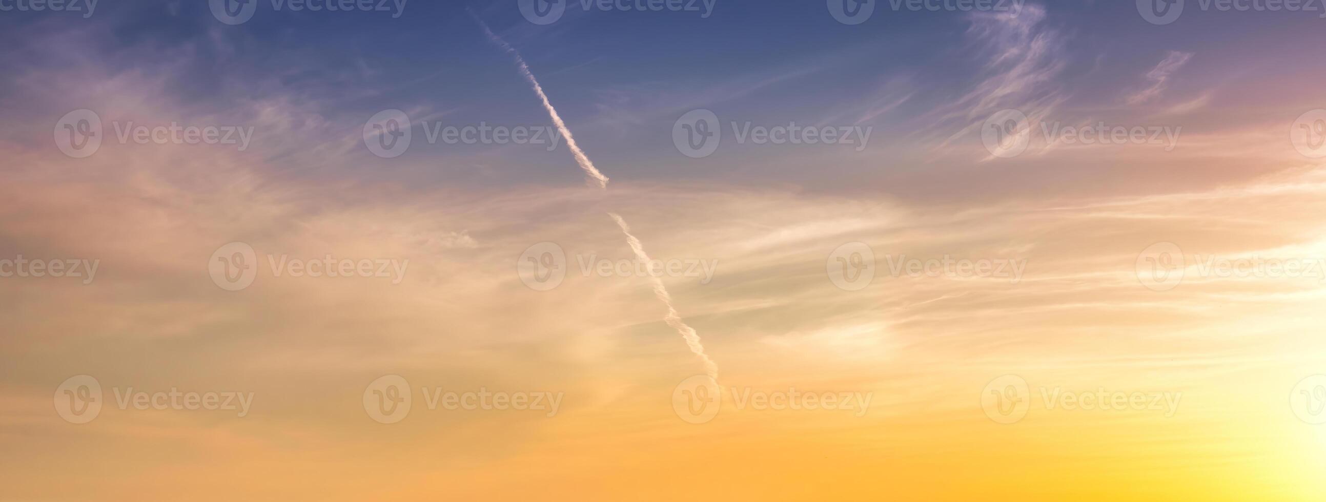 Colorful dramatic clouds lit by a sun against the sunset or sunrise sky. photo