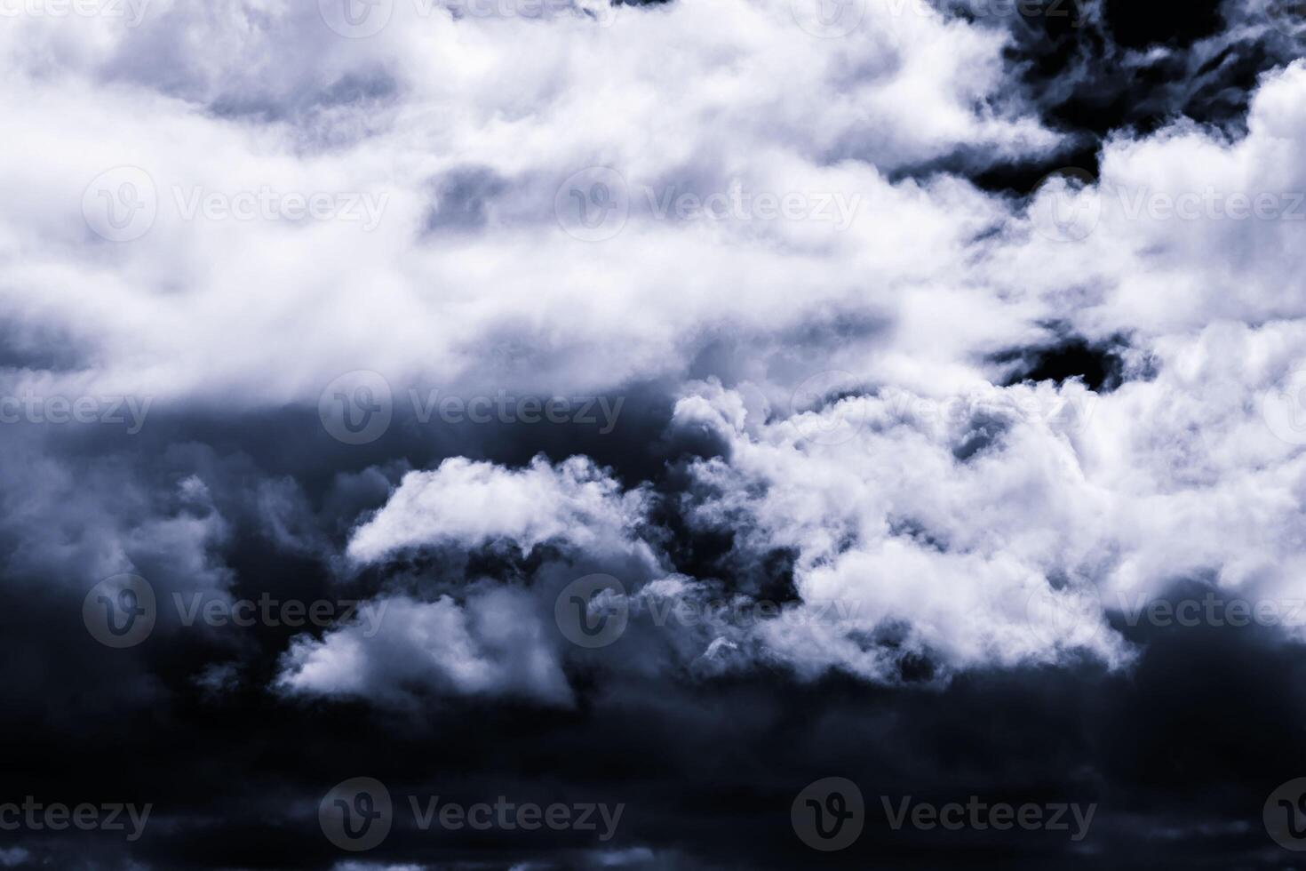 Dark monochrome heavy storm clouds before a thunderstorm or hurricane. Dramatic clouds in overcast weather. photo