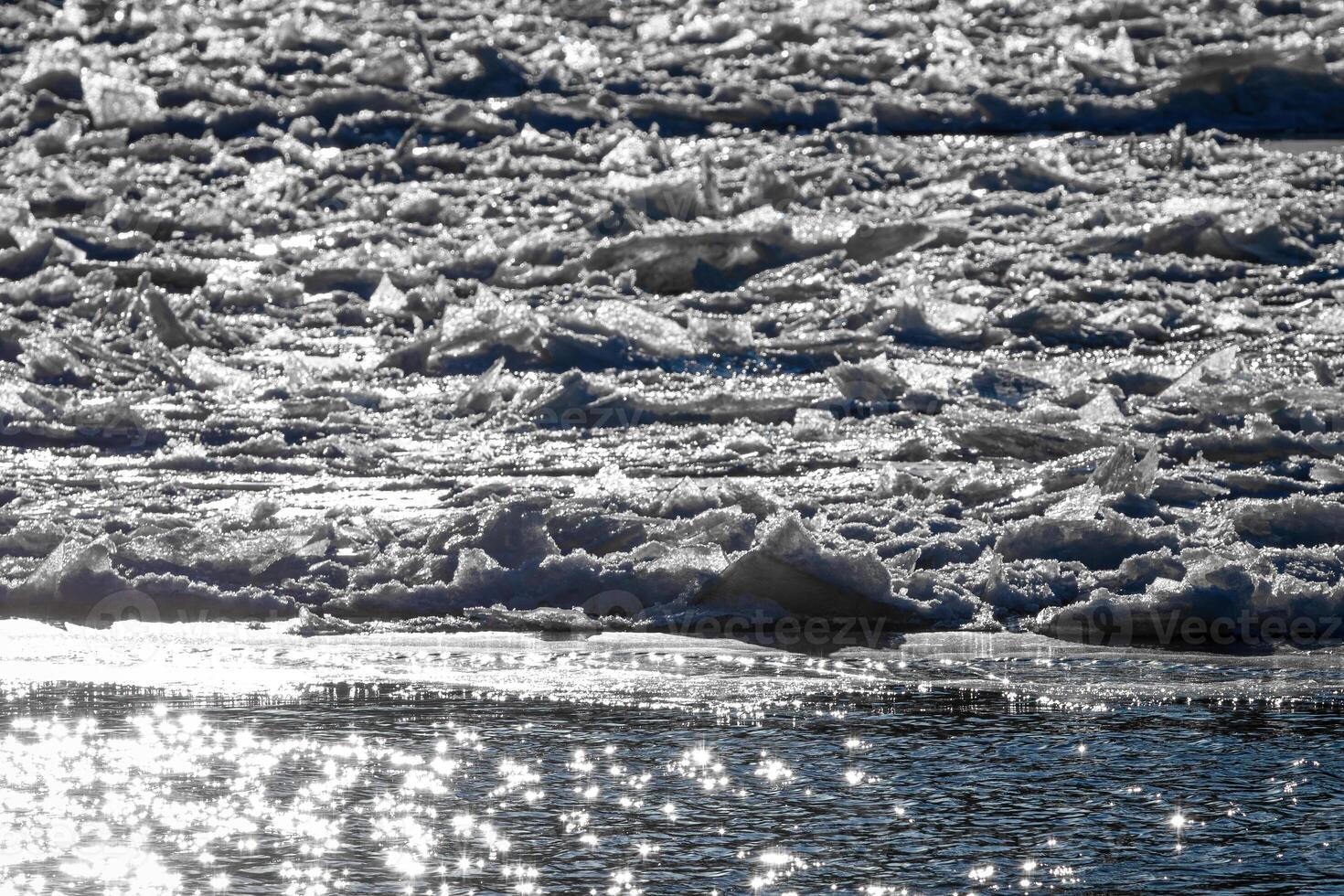 Melting ice floating on the river on a spring day. Cracked ice texture. photo