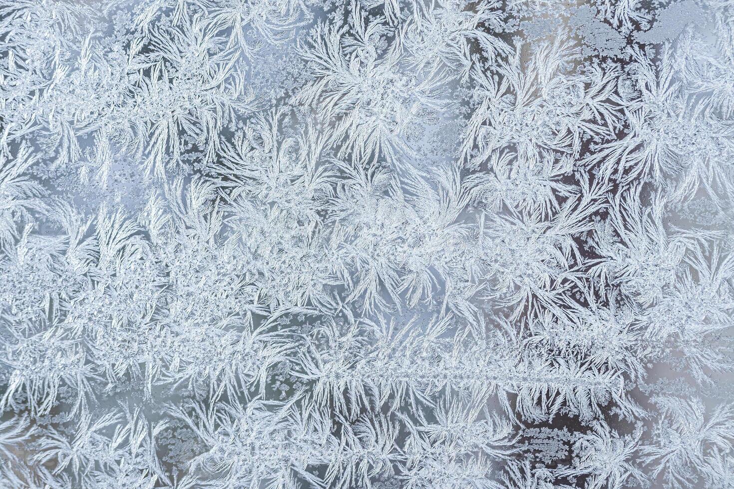 The texture of the glass covered with frost in winter in cold weather. Abstract background. photo