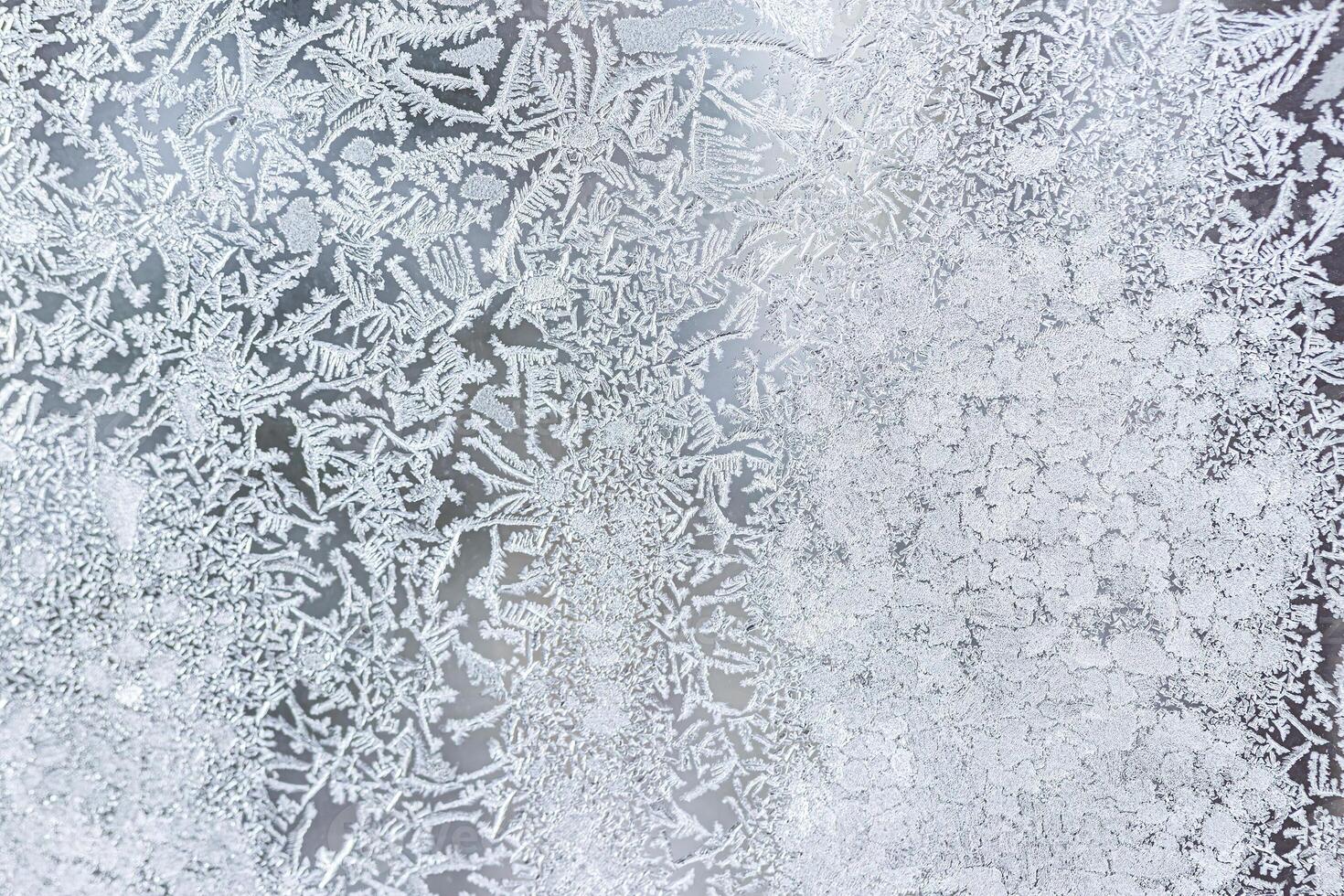 The texture of the glass covered with frost in winter in cold weather. Abstract background. photo