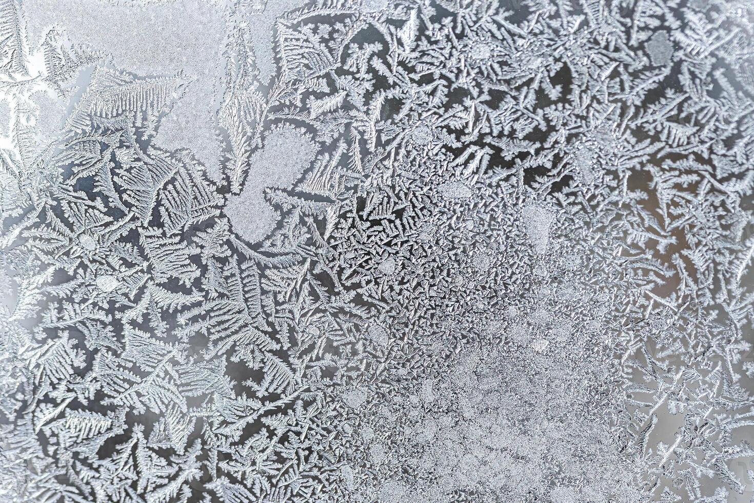 The texture of the glass covered with frost in winter in cold weather. Abstract background. photo