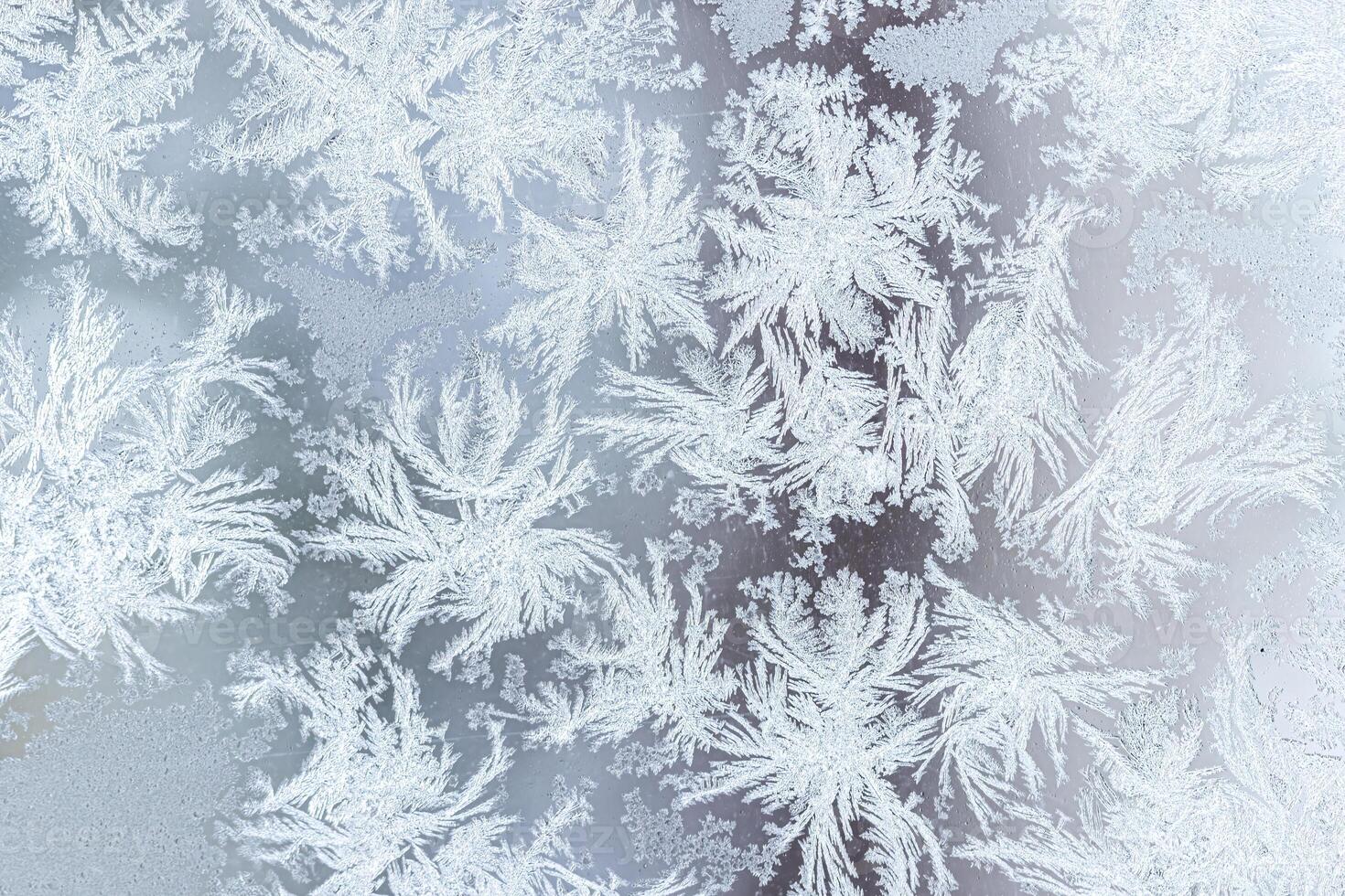 The texture of the glass covered with frost in winter in cold weather. Abstract background. photo