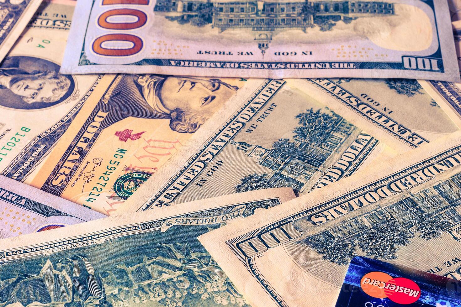 Photo of Mastercard credit card with USA dollars bills.
