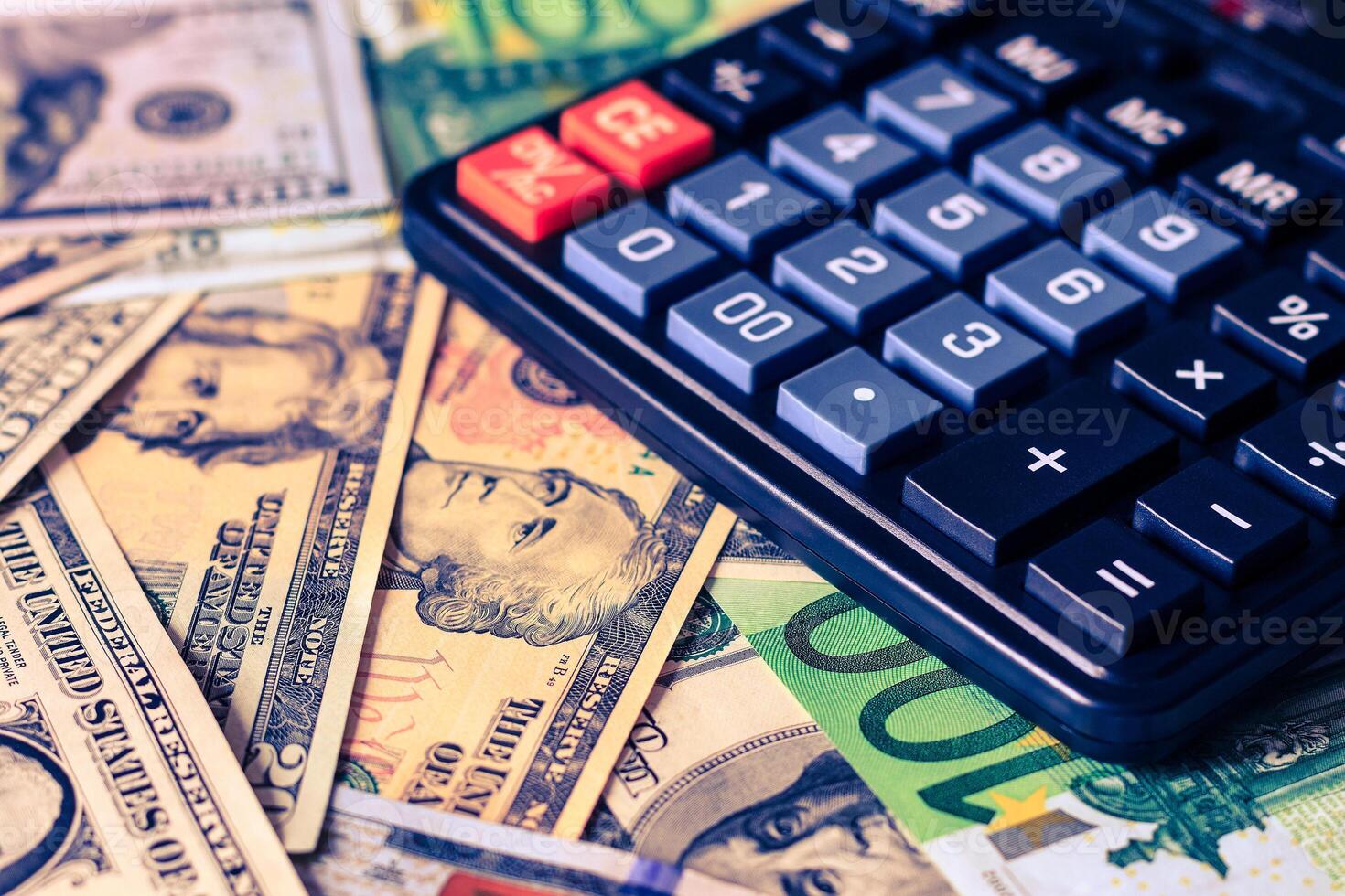 Dollar and euro bils and black calculator. photo