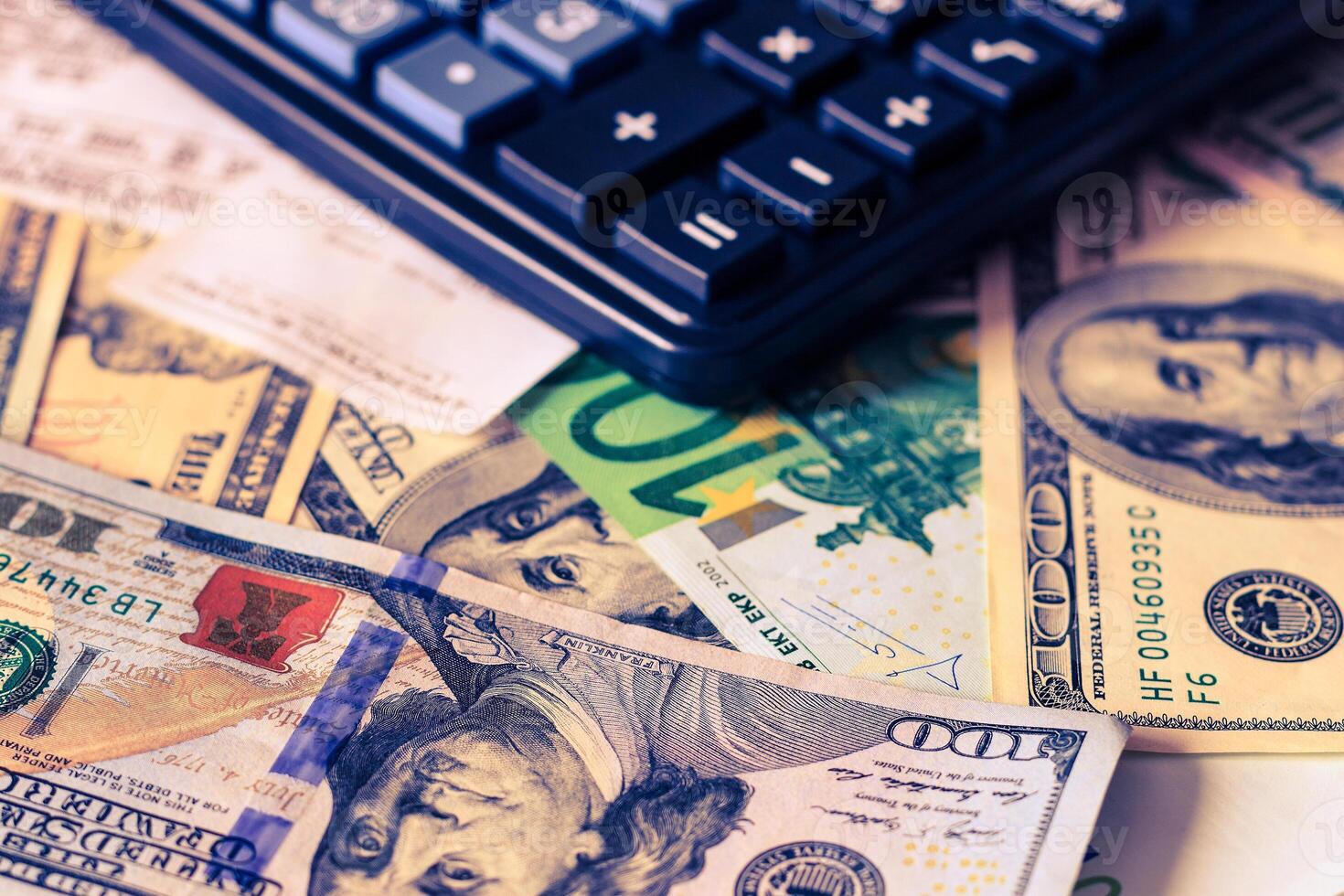 Dollar and euro bils, check and black calculator. photo