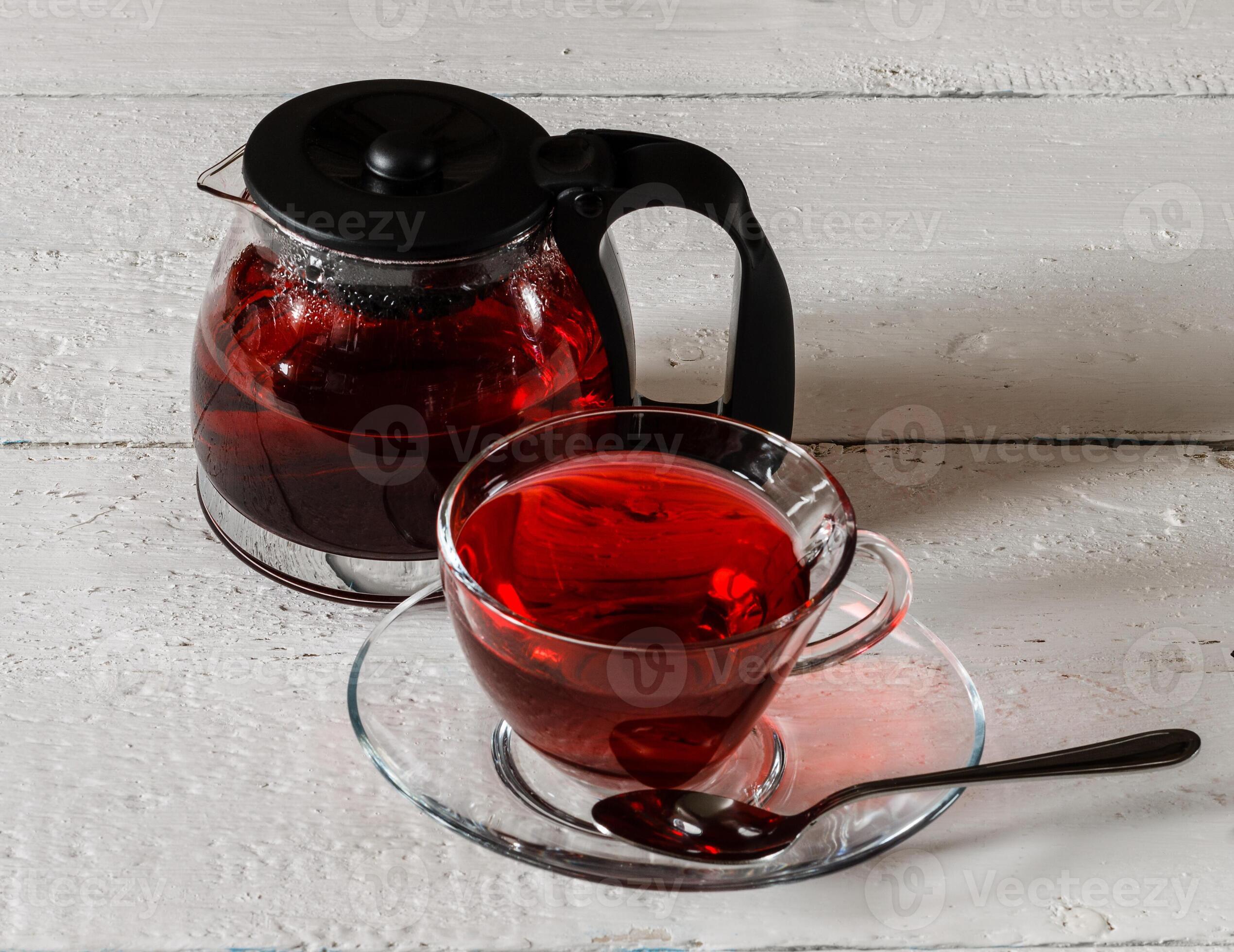 Cup of Karkadeh Red Tea and kettle on wooden table 46214938 Stock Photo ...