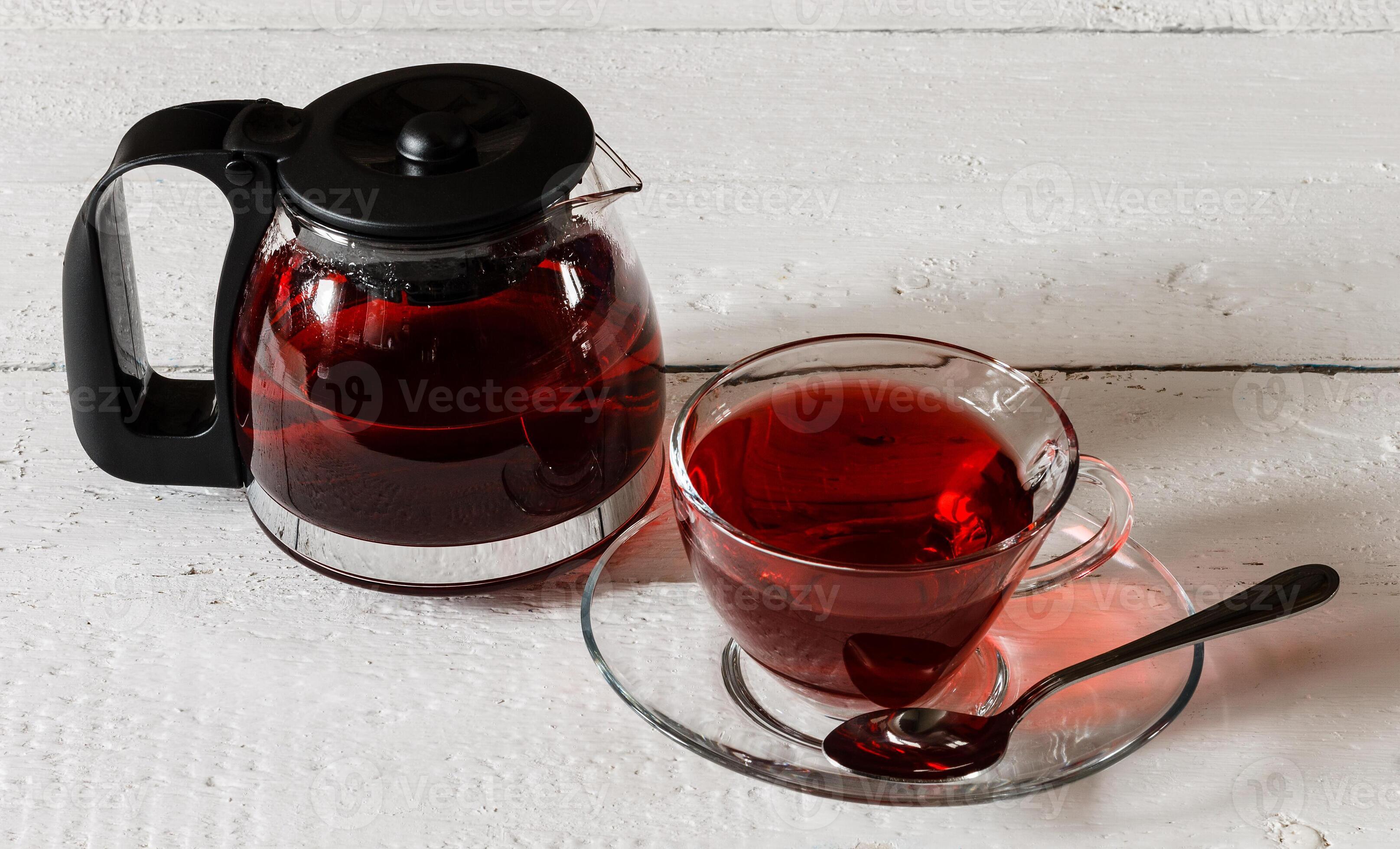 Cup of Karkadeh Red Tea and kettle on wooden table 46214944 Stock Photo ...