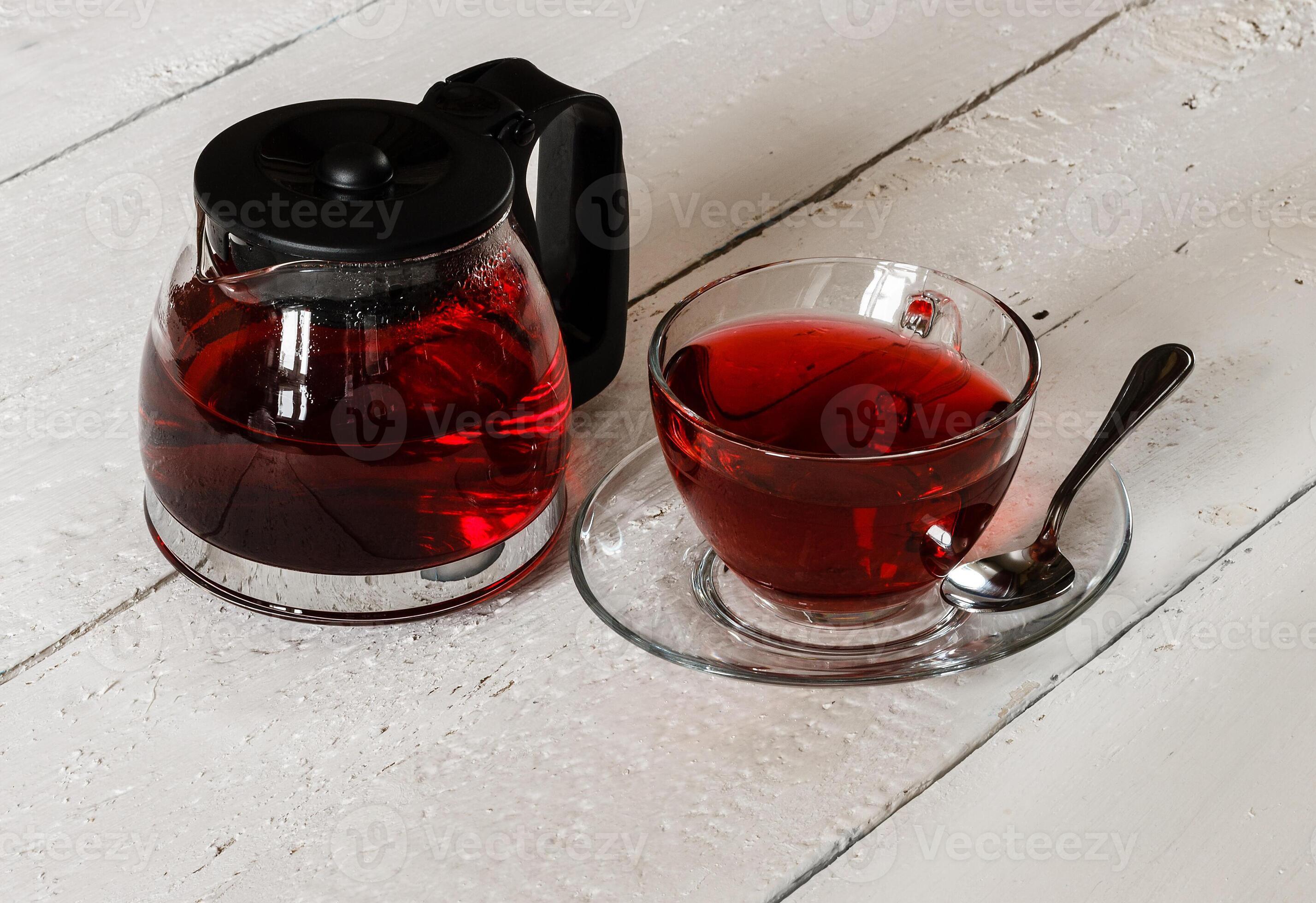 Cup of Karkadeh Red Tea and kettle on wooden table 46214947 Stock Photo ...