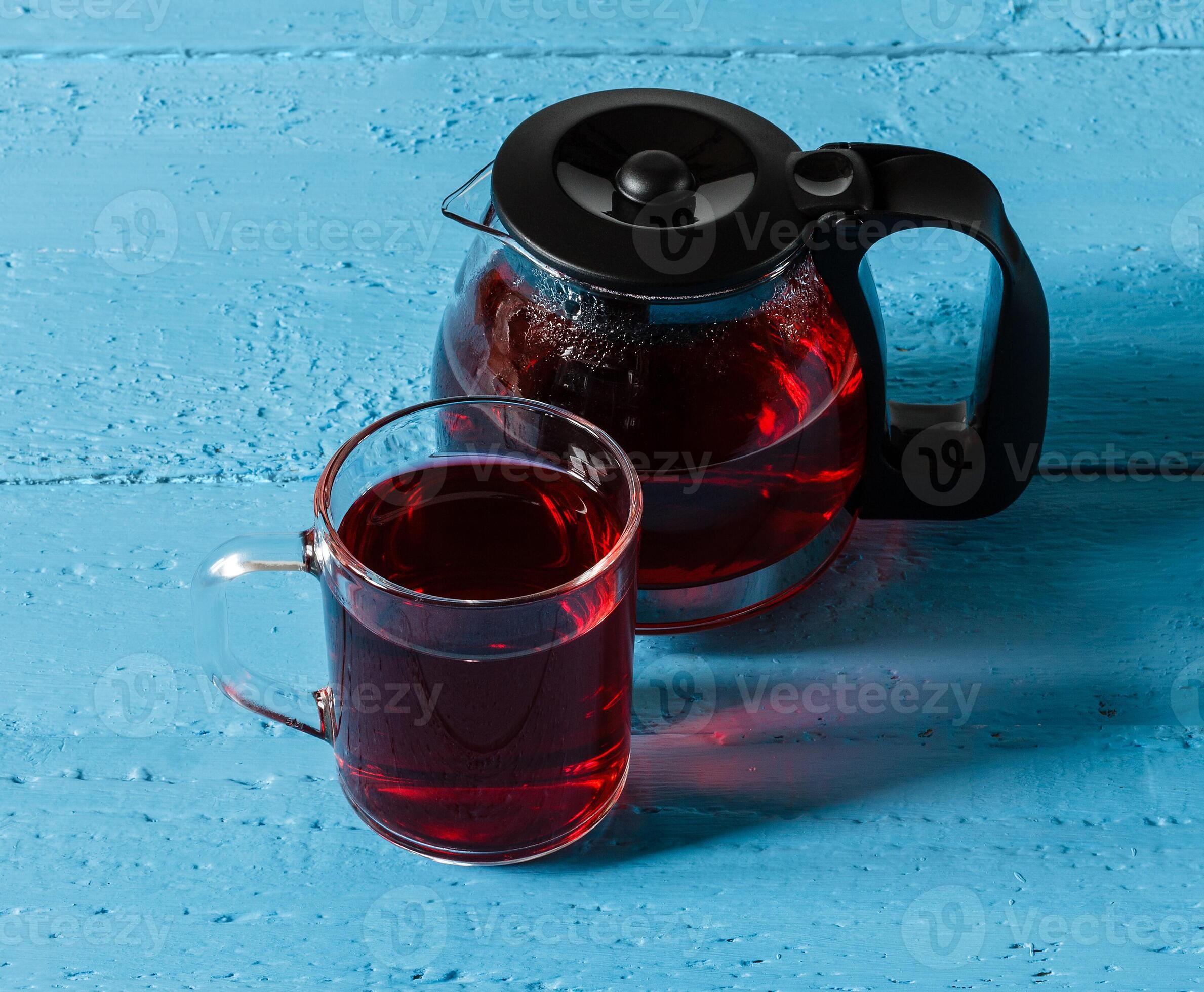 Cup of Karkadeh Red Tea and kettle on wooden table 46214976 Stock Photo ...