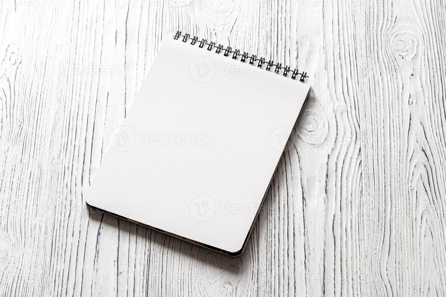 The notebook on a white table with a copy space. photo