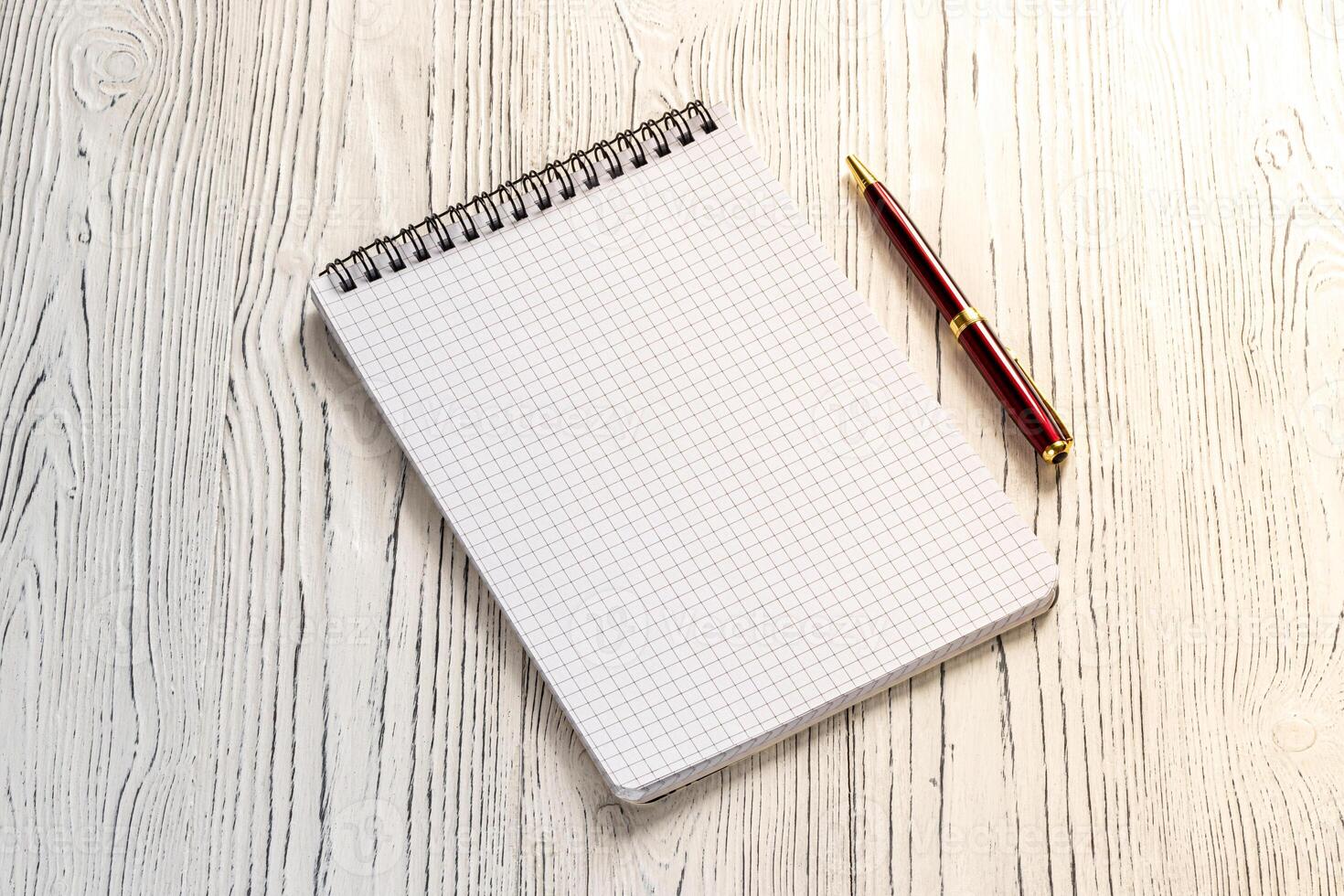 The notebook and pen on a white table with a copy space. photo