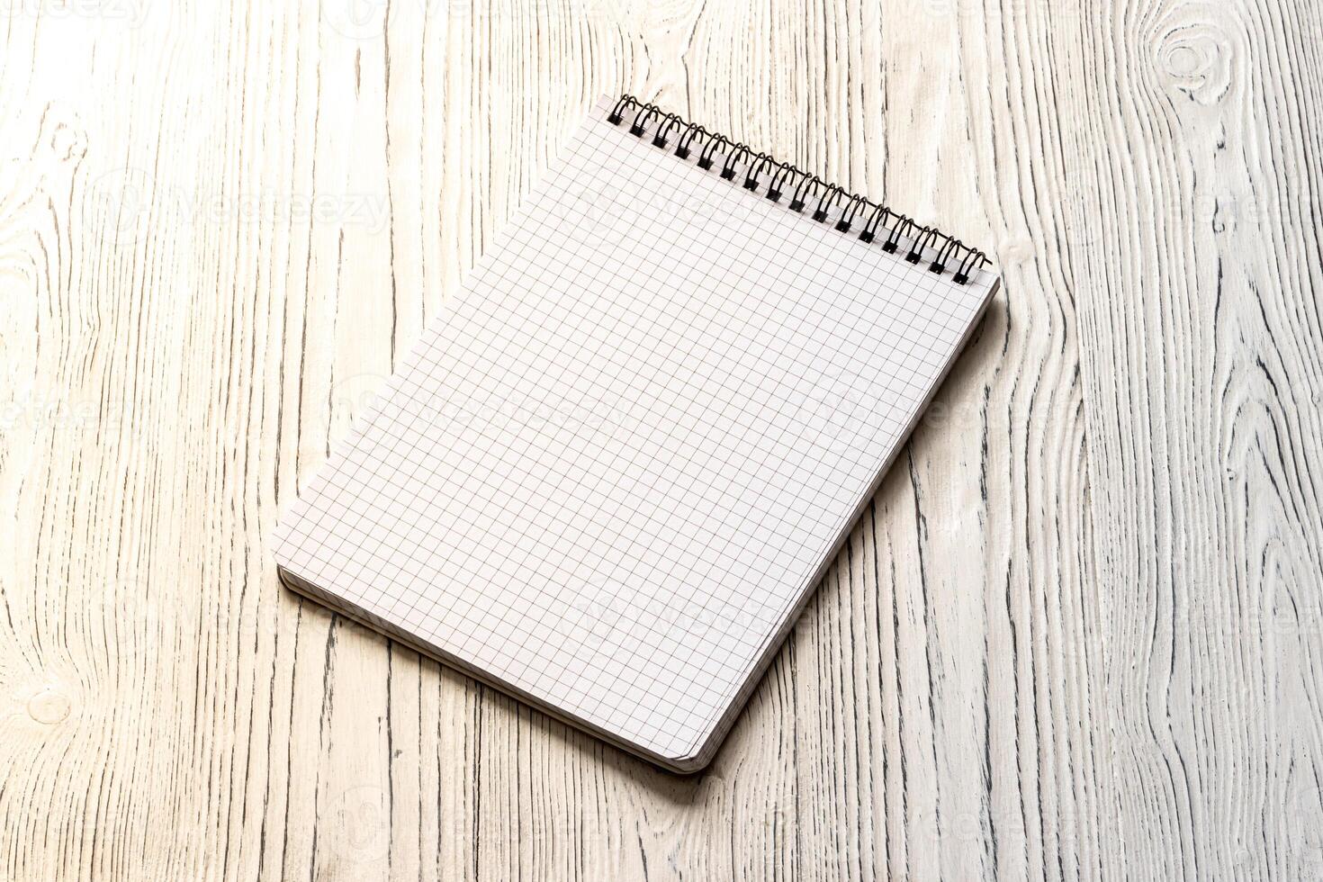 The notebook on a white table with a copy space. photo