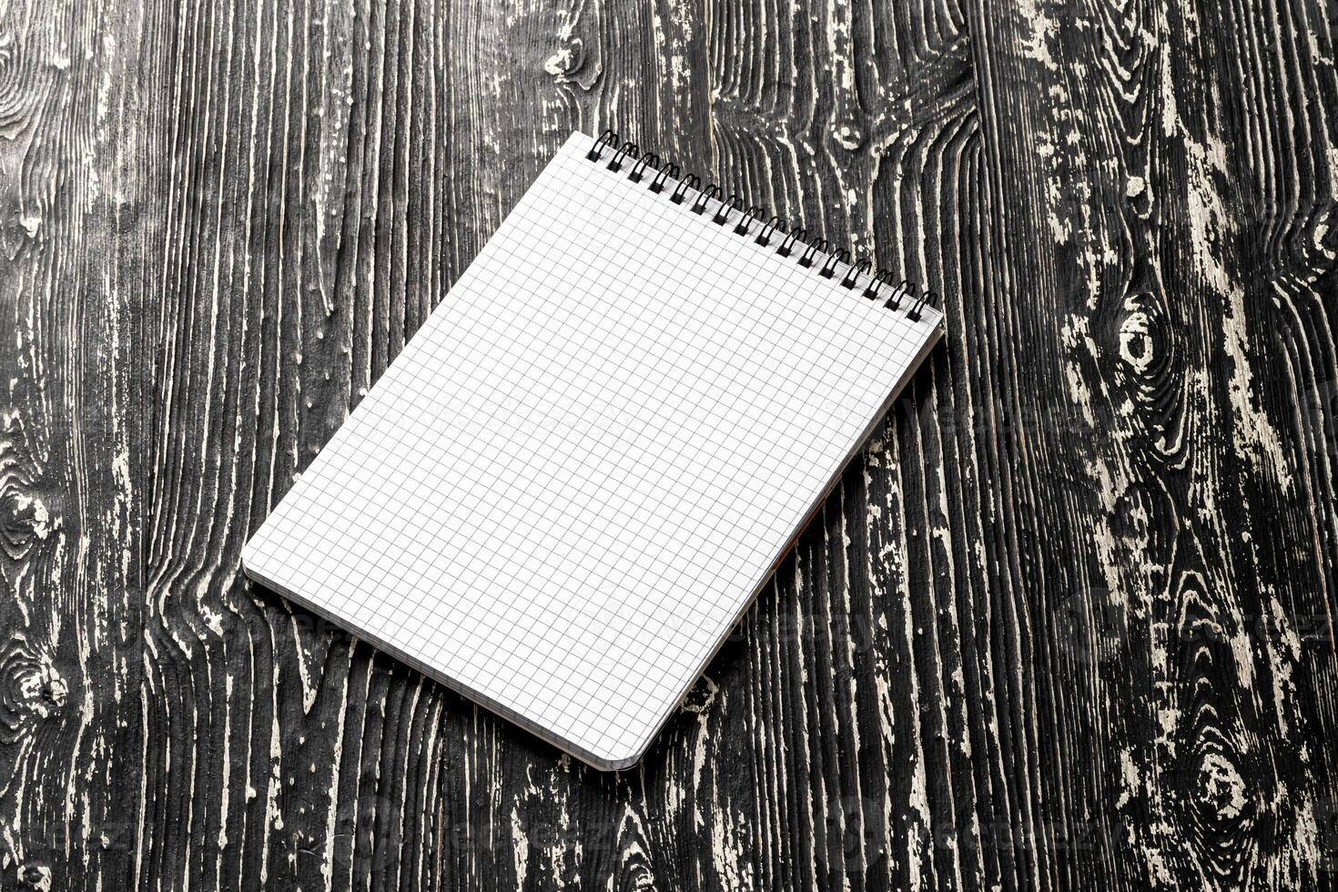 The notebook on a black table with a copy space. Template for mock up and presentation design. photo