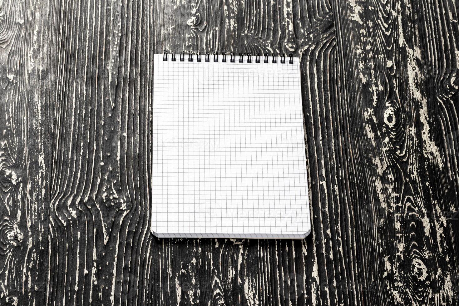 The notebook on a black table with a copy space. Template for mock up and presentation design. photo