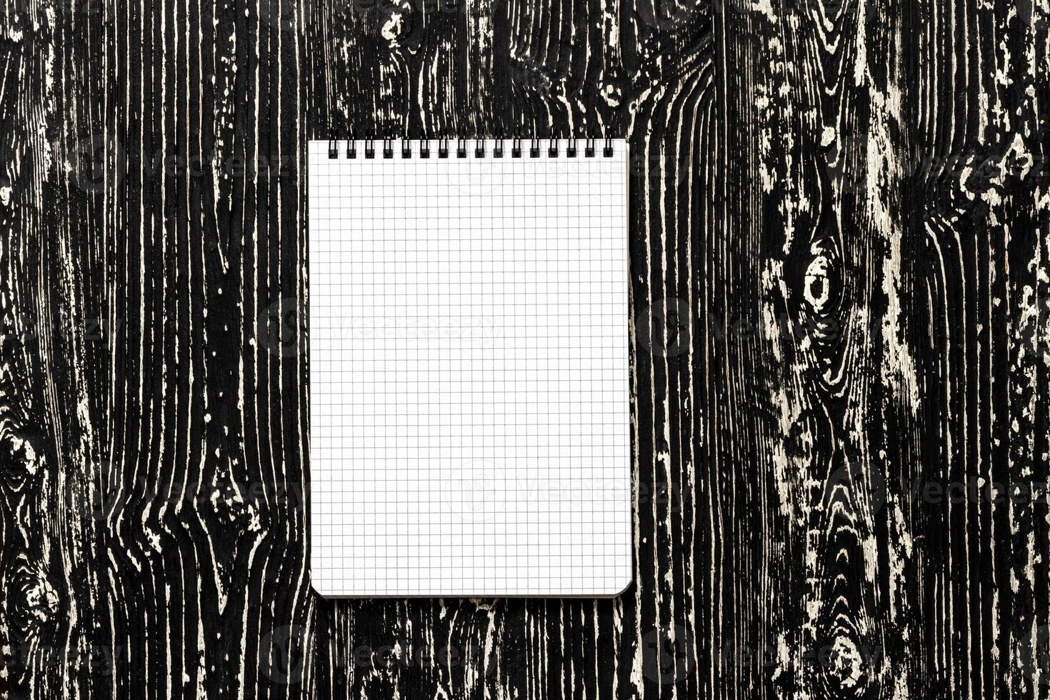 The notebook on a black table with a copy space. Template for mock up and presentation design. photo