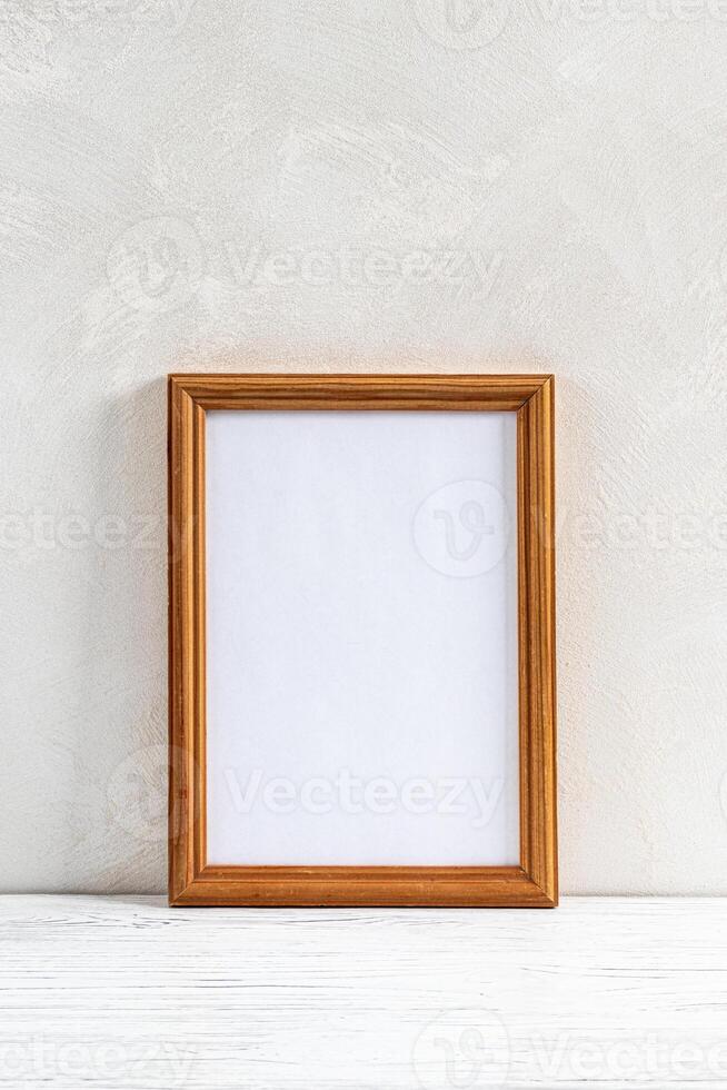 Wooden floor over concrete or decorative plaster wall and photo frame with copy space for a text background.