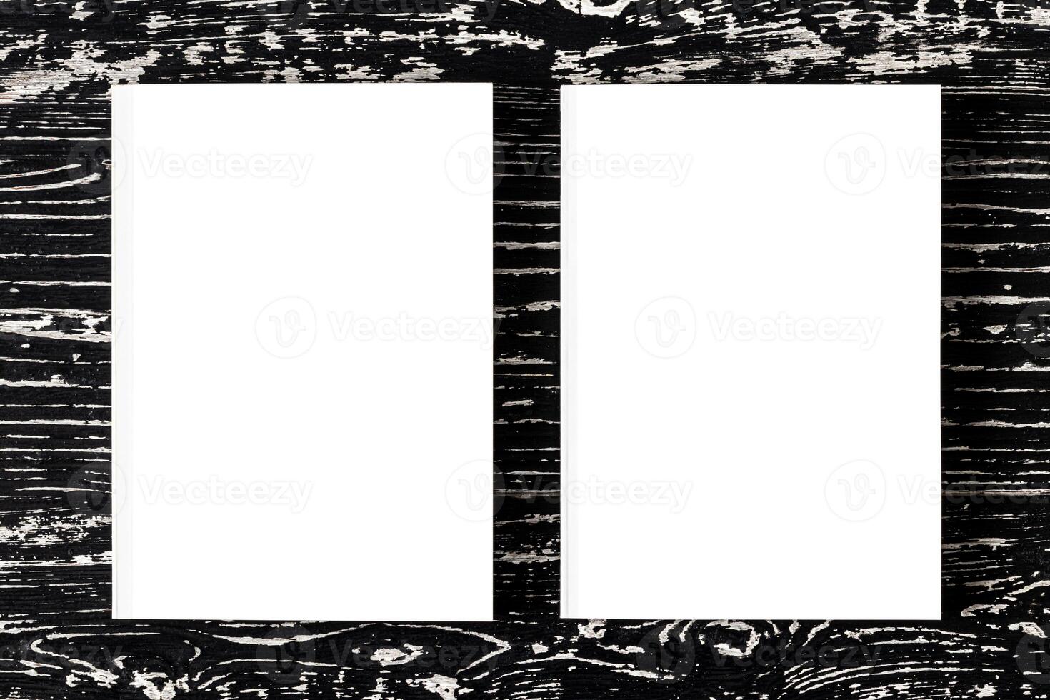 Two white books on a black wooden table. photo