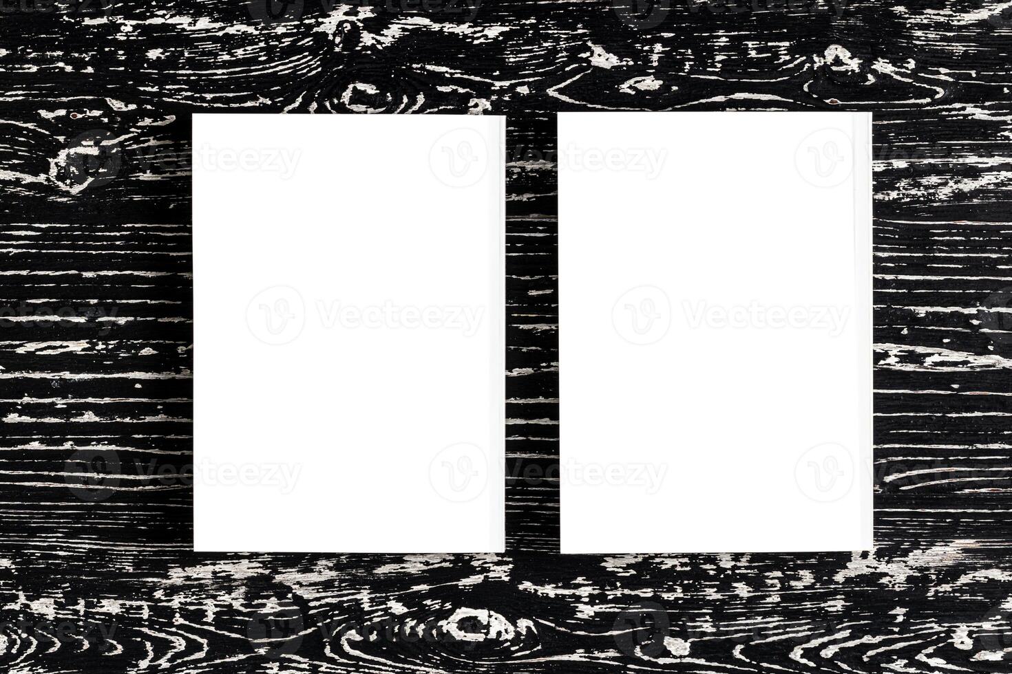 Two white books on a black wooden table. photo