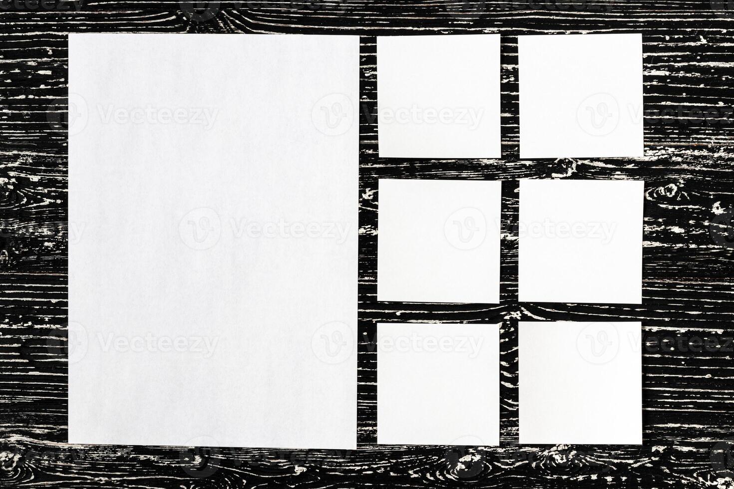White paper sheets and cup of coffee on a black wooden table. photo