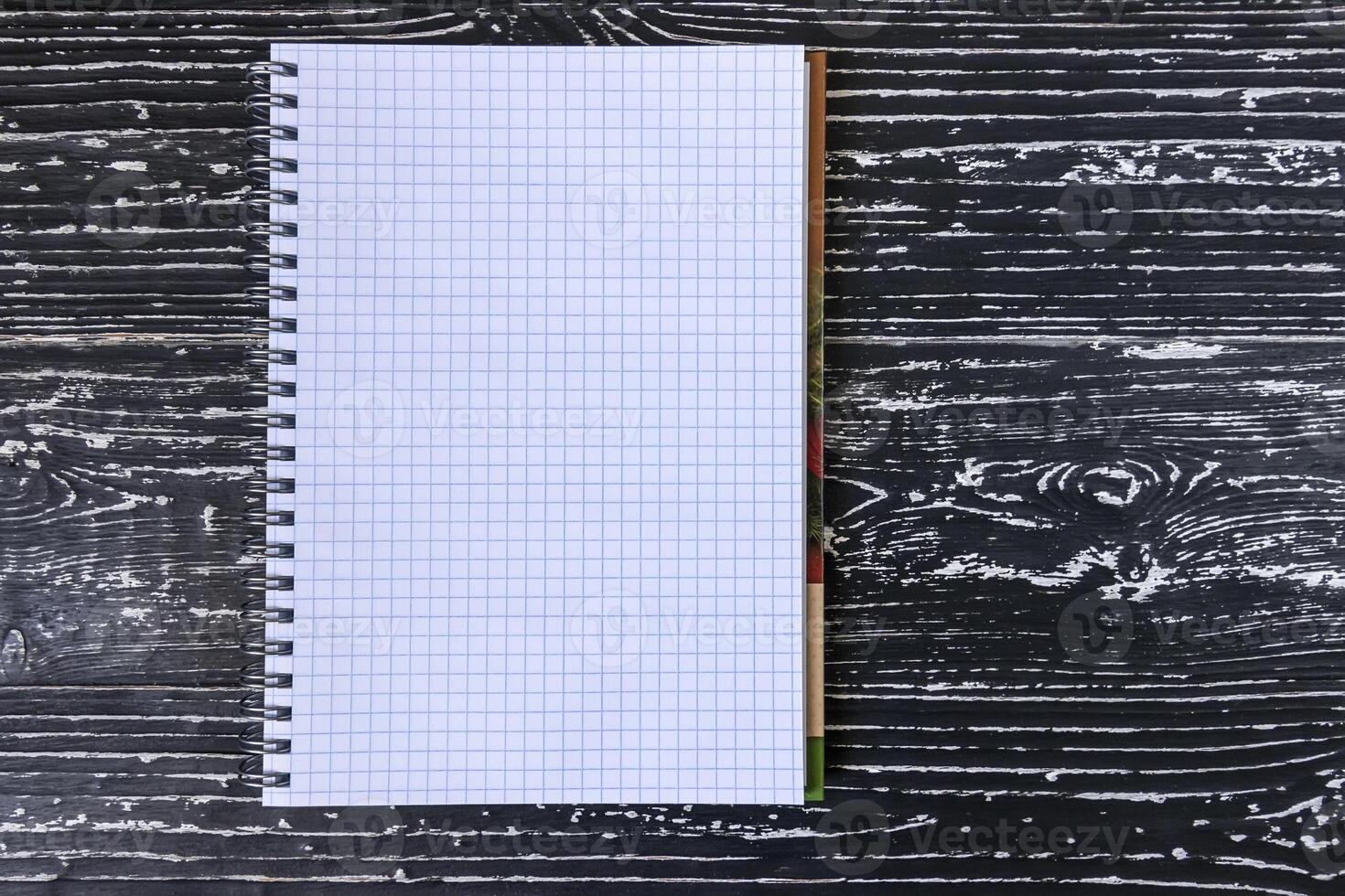 The notebook on a white black table with a copy space. photo
