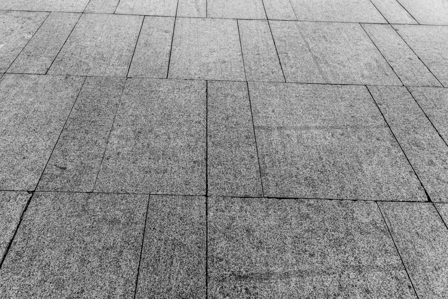 Top view on paving stone road. Old pavement of granite texture. Street cobblestone sidewalk. photo