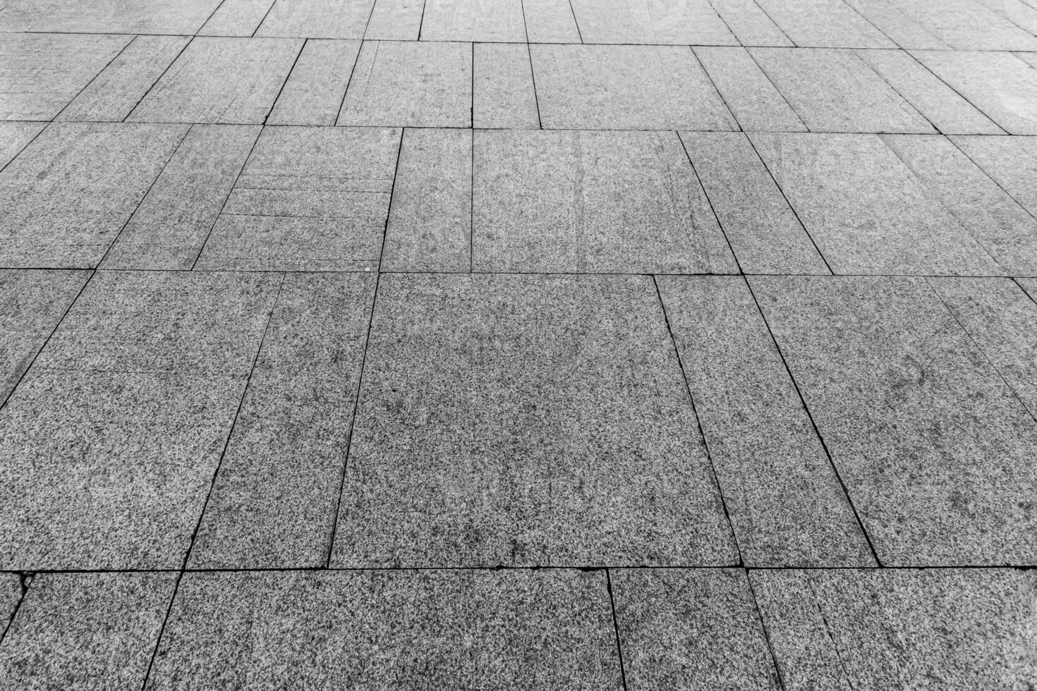 Top view on paving stone road. Old pavement of granite texture. Street cobblestone sidewalk. photo