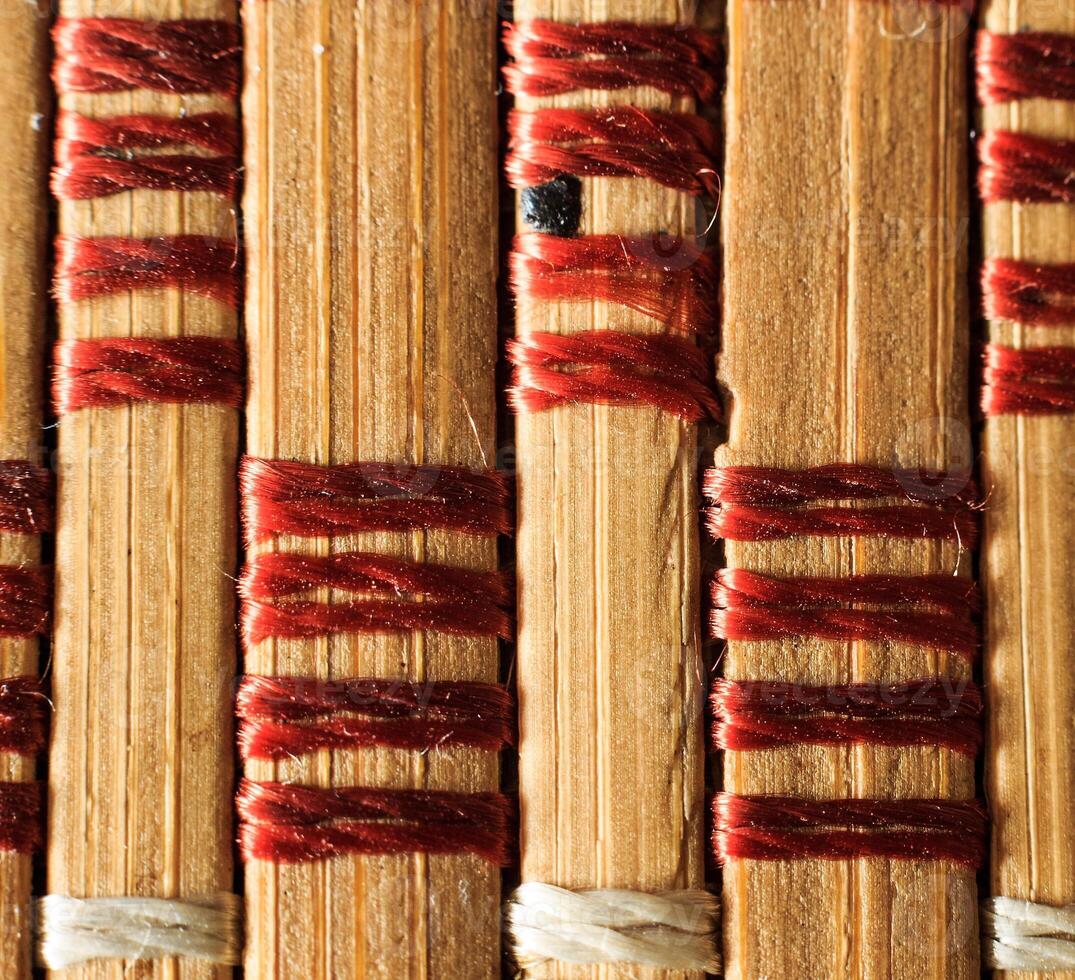 Texture of old bamboo branches with threads. photo