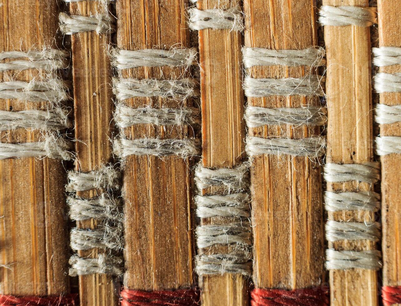 Texture of old bamboo branches with threads. photo