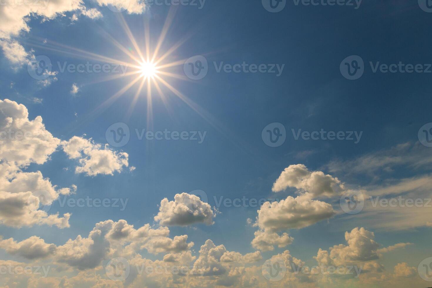 Blue sky with clouds and sun photo