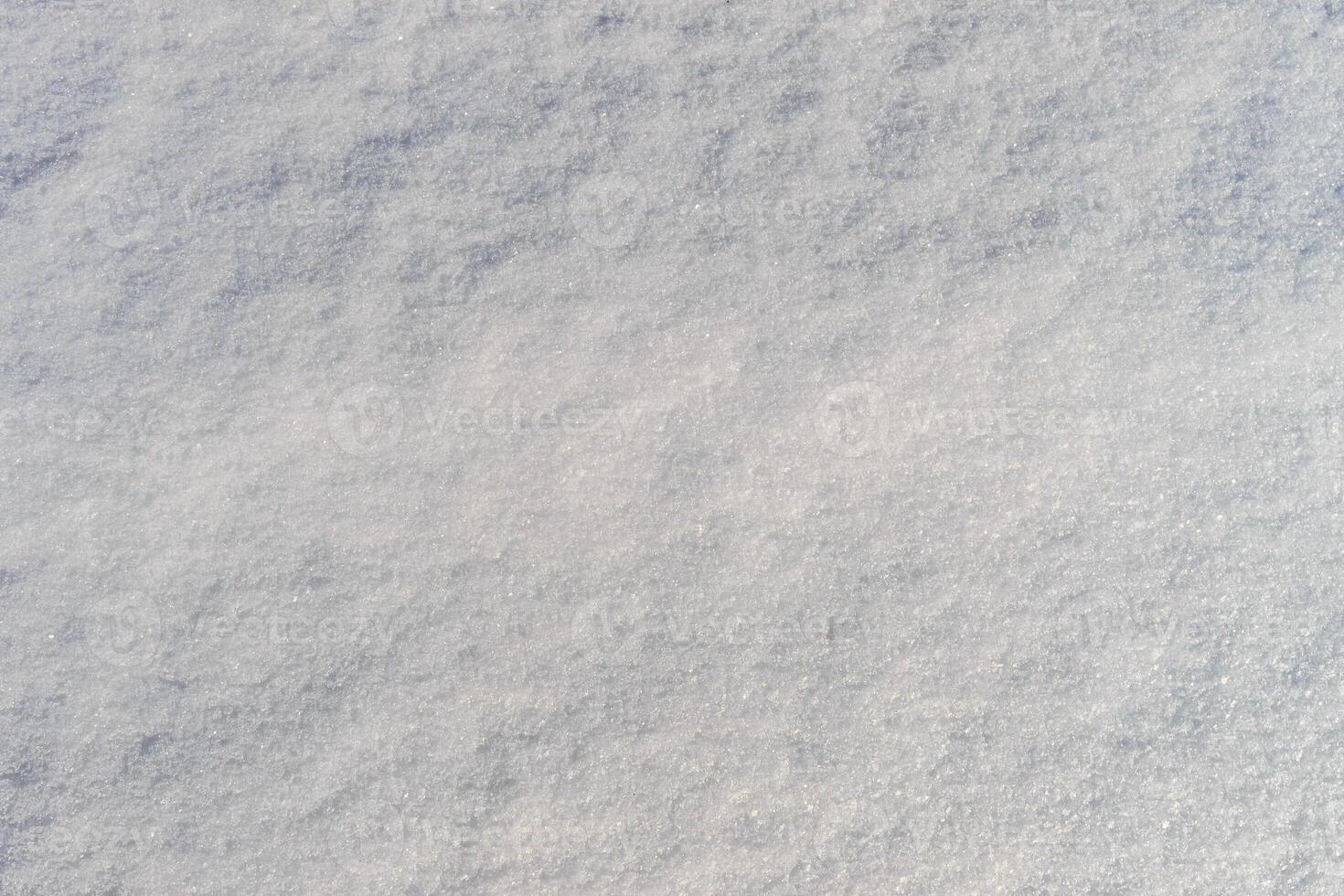 Snow texture at sunny winter day. Abstract background. photo