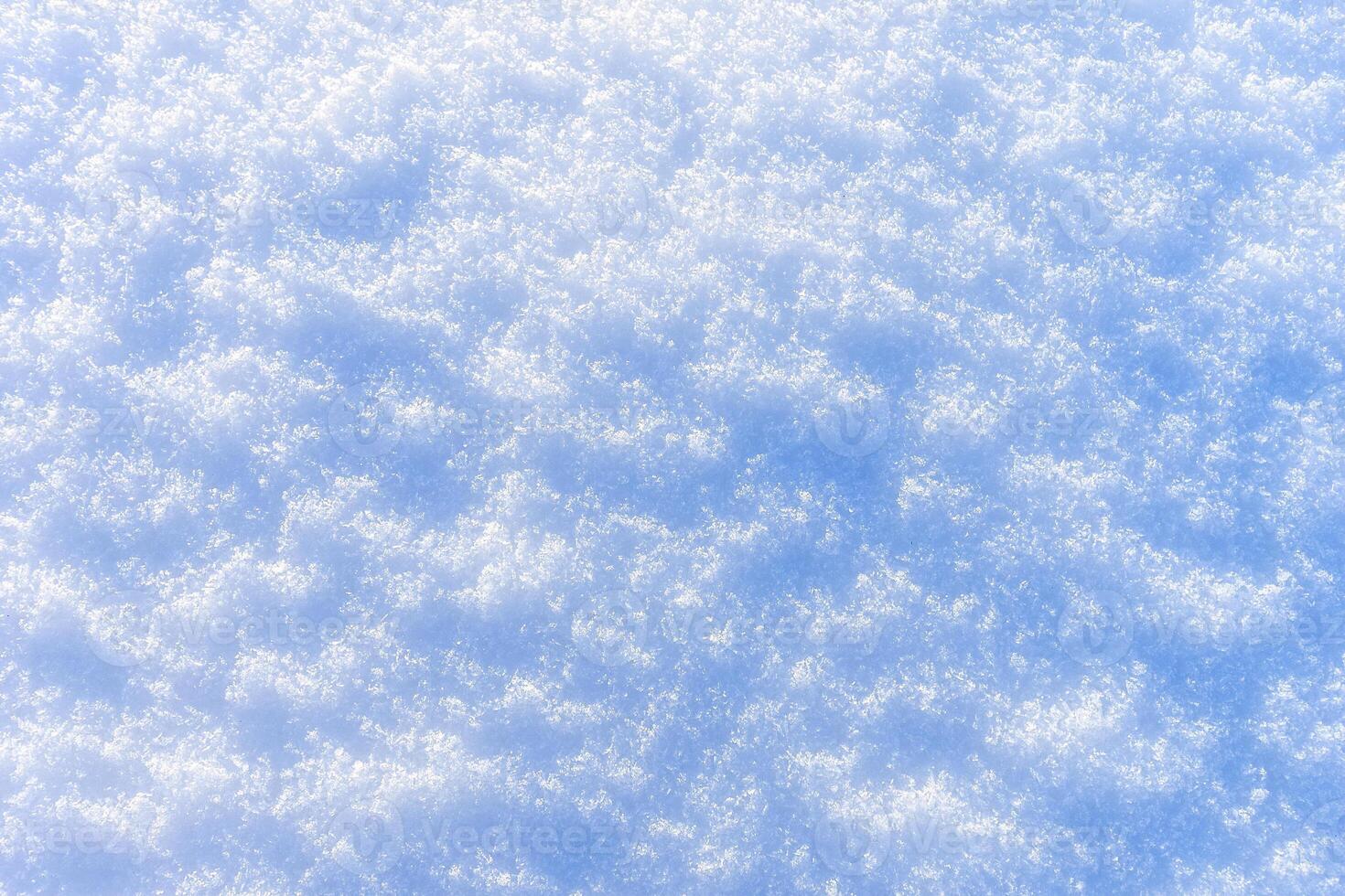 Snow texture at sunny winter day. Abstract background. photo
