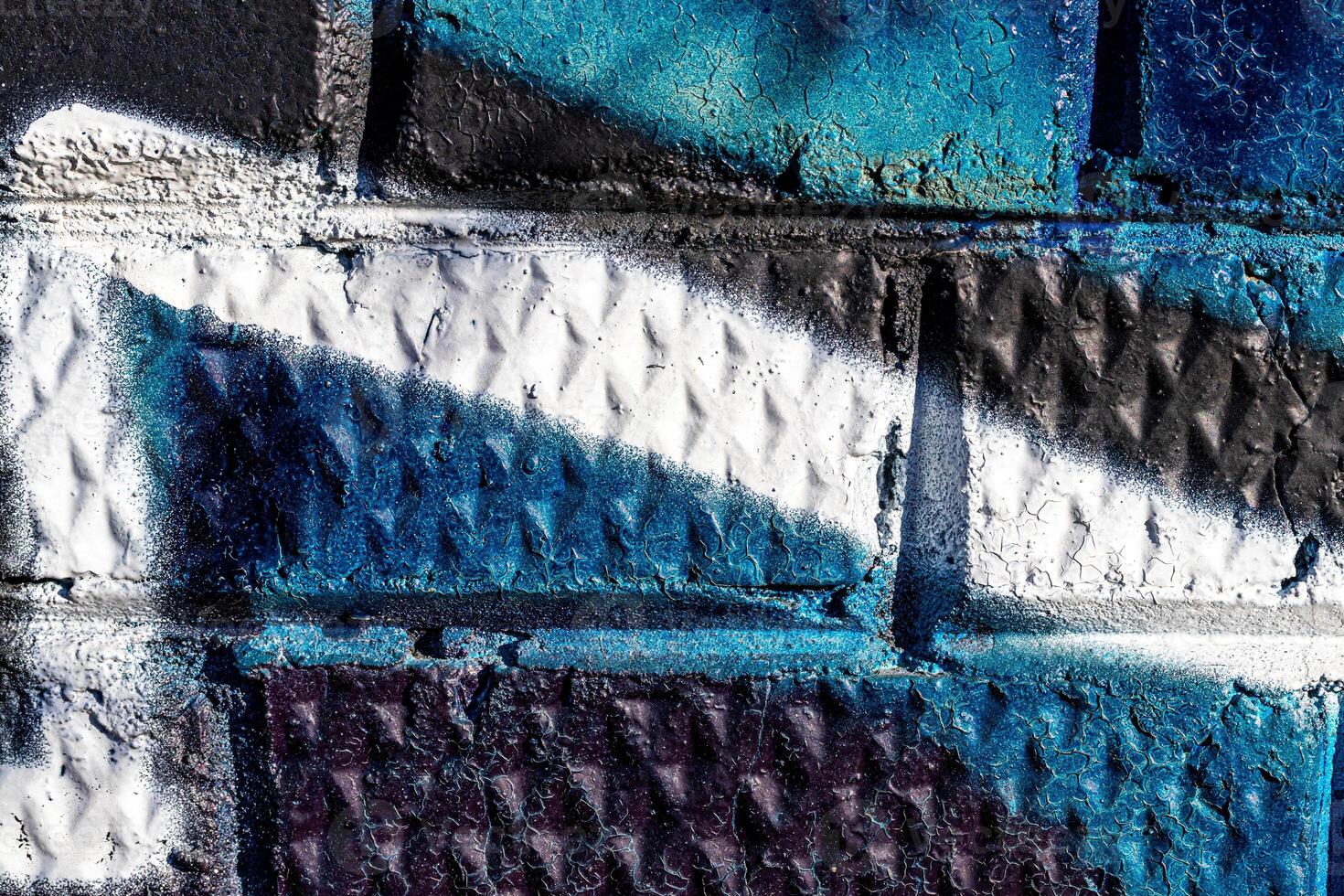 Fragment of colored graffiti painted on a brick wall. Abstract background for design. photo