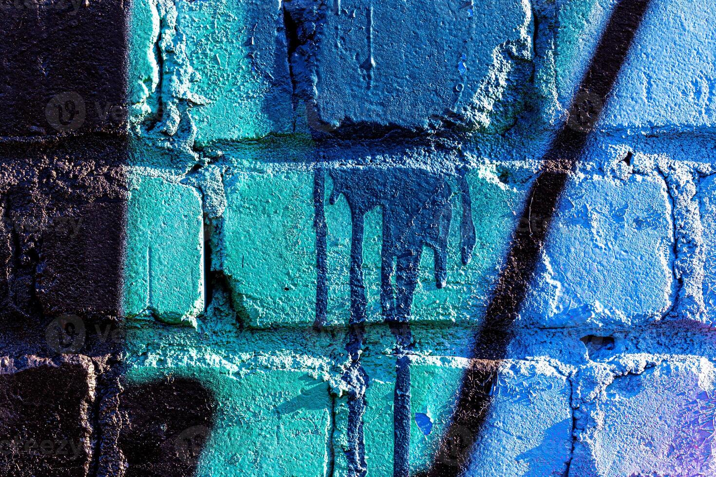 Fragment of colored graffiti painted on a brick wall. Abstract backdrop for design. photo