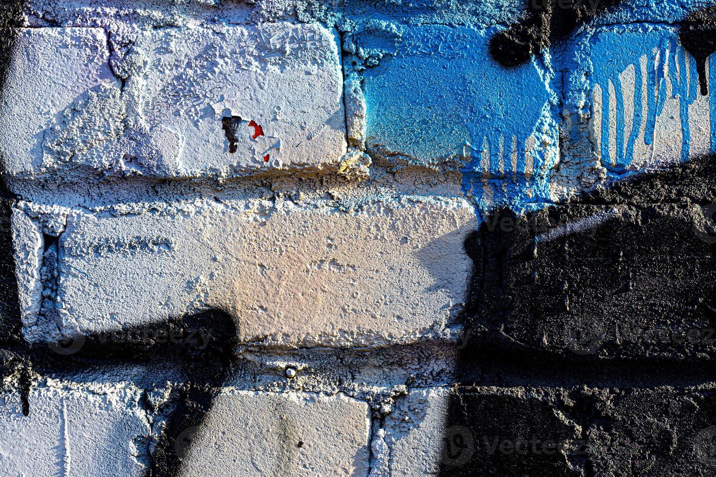 Fragment of colored graffiti painted on a brick wall. Abstract background for design. photo