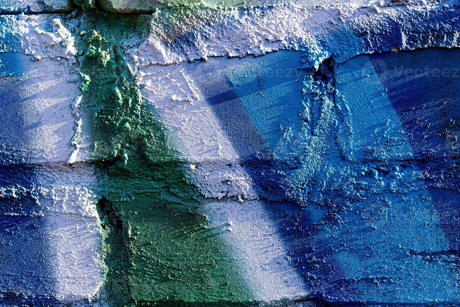 Fragment of colored graffiti painted on a brick wall. Abstract backdrop for design. photo