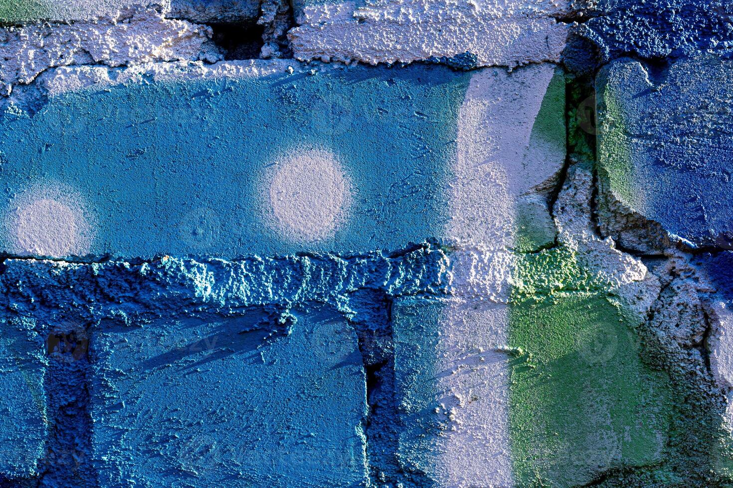 Fragment of colored graffiti painted on a brick wall. Abstract backdrop for design. photo