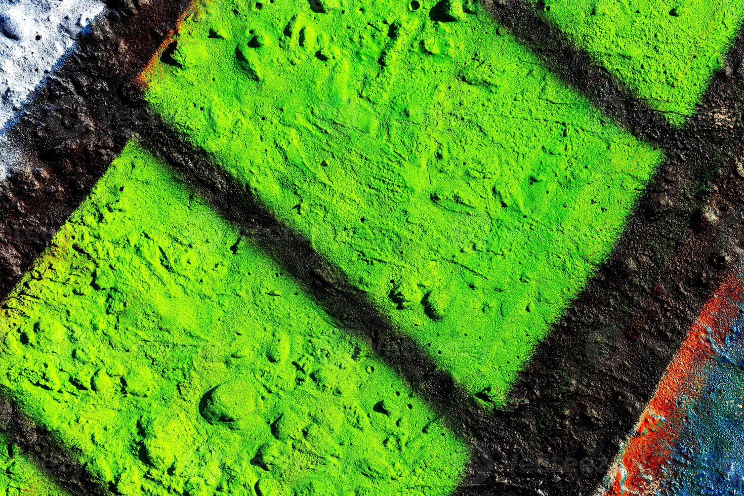 Fragment of colored graffiti painted on a concrete wall. Abstract background for design. photo