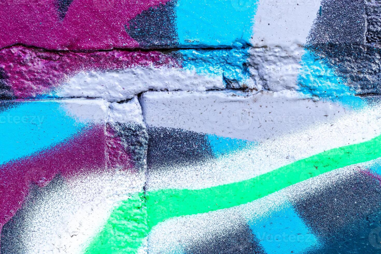 Fragment of colored graffiti painted on a brick wall. photo