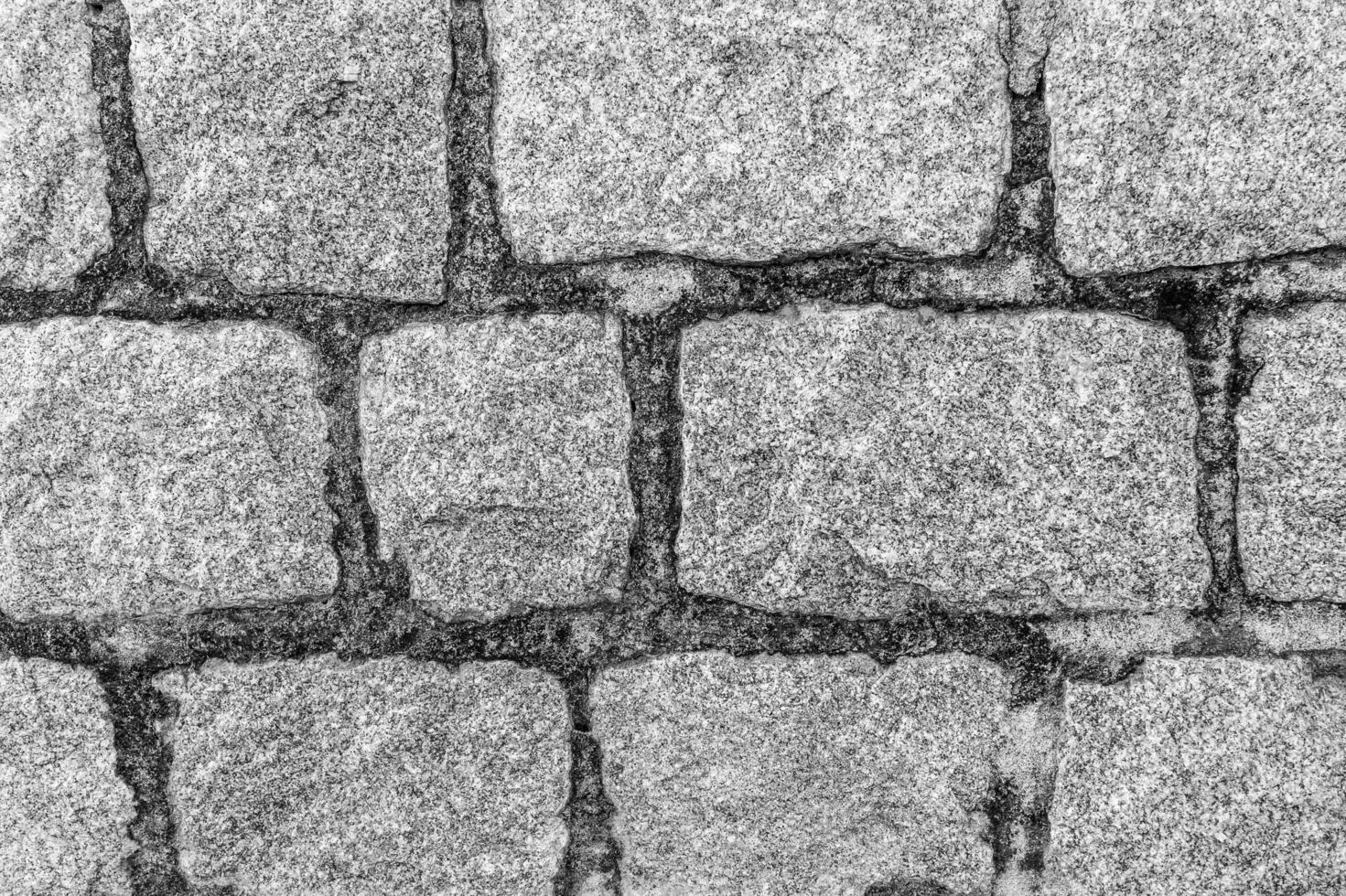 Monochrome background of old stone brick wall. photo