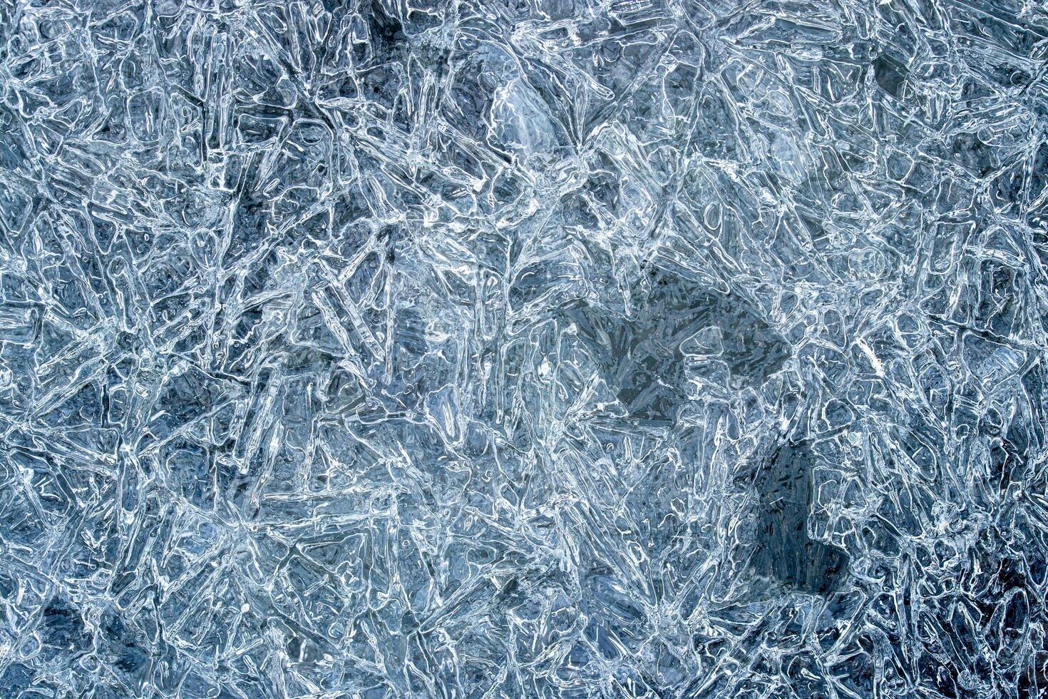 Texture of ice in the winter. Abstract background for design, photographed closeup. photo
