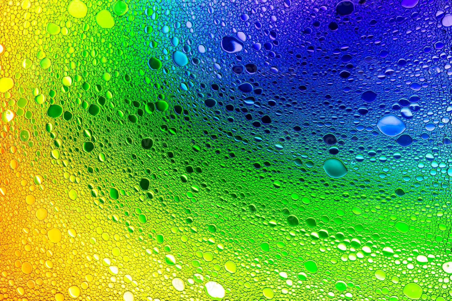 Rainbow color drops of oil on the water. photo